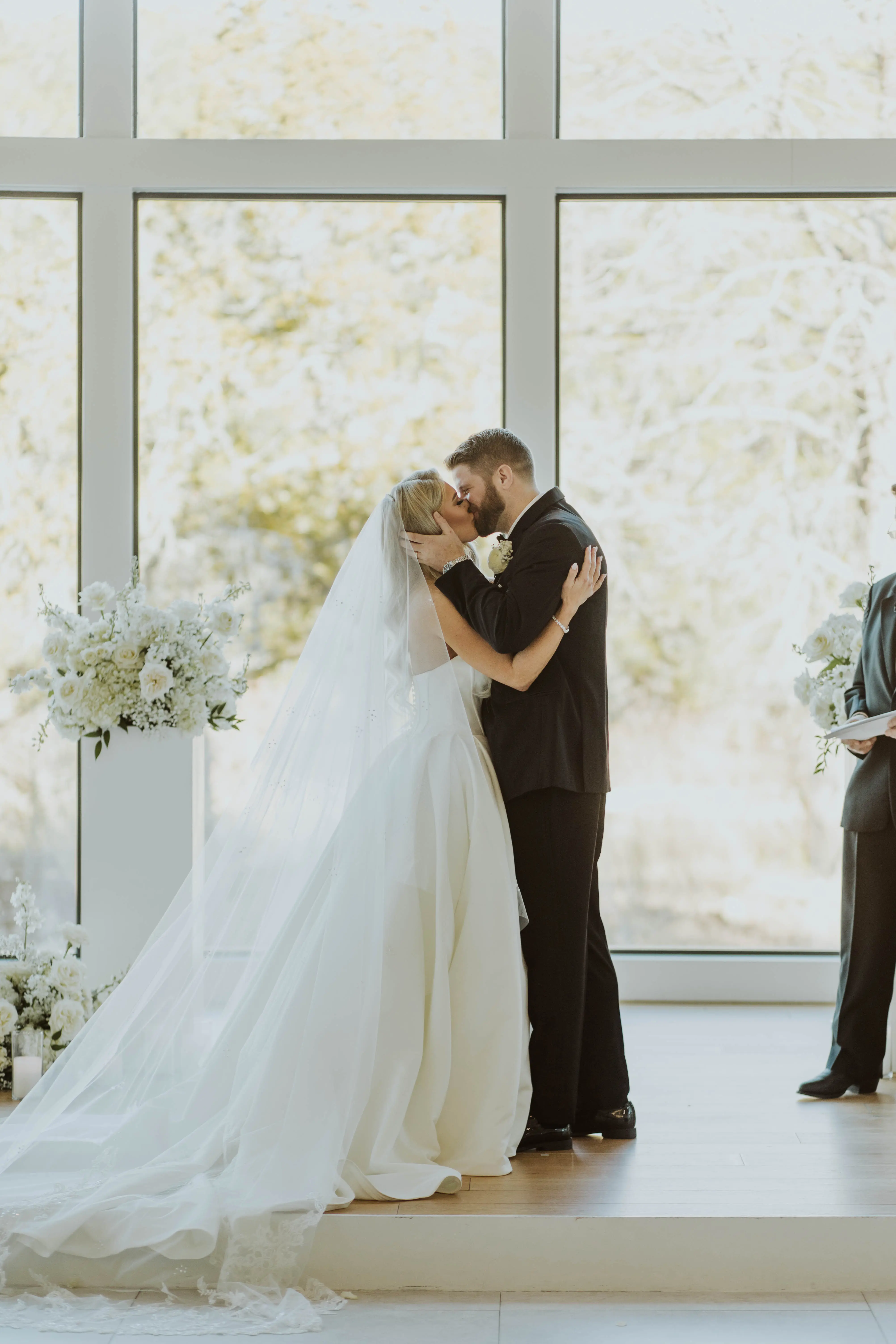 Bride wearing Derrick by Maggie Sottero kissing her husband