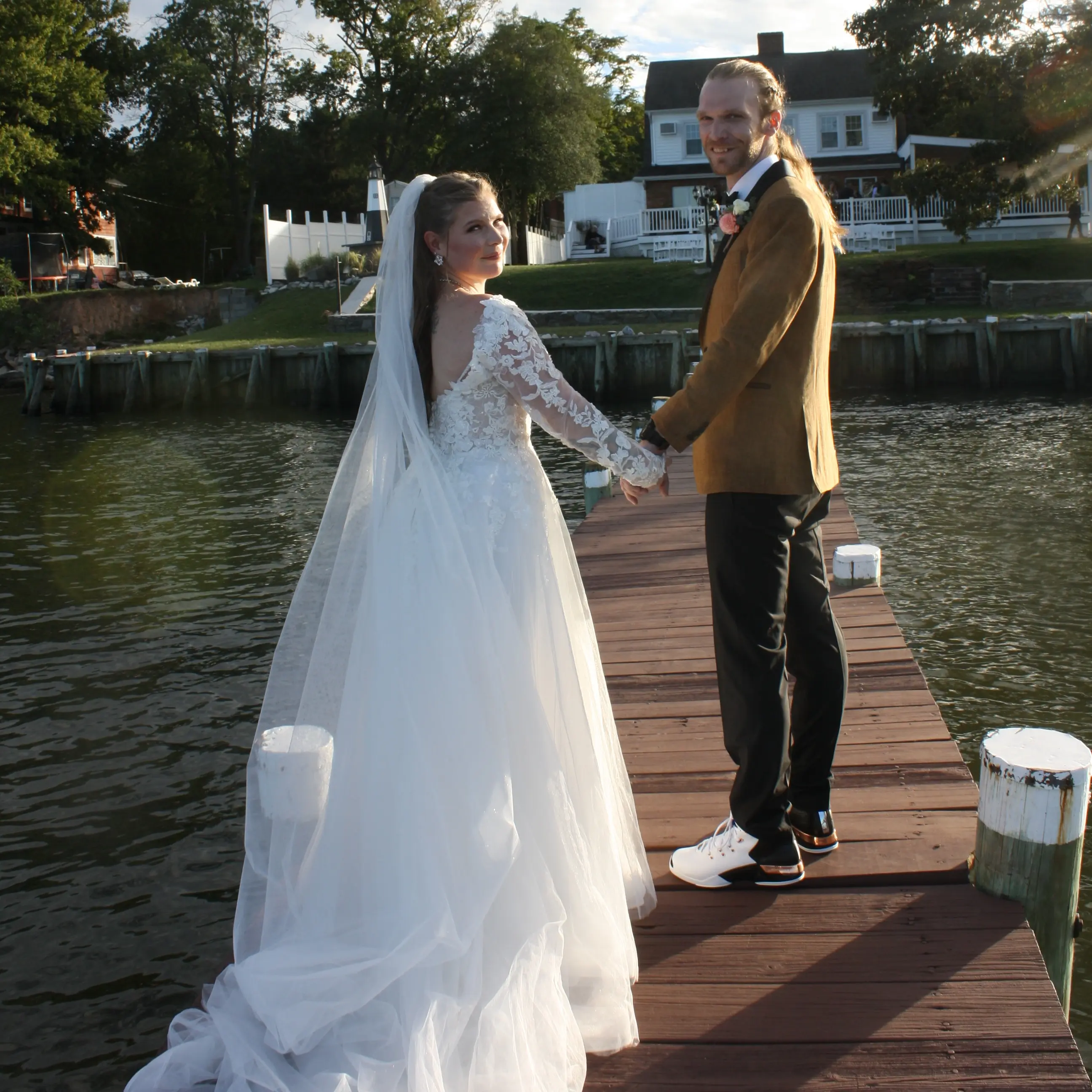 Bride Wearing Princess Wedding Dress With Long Sleeves Called Stevie By Maggie Sottero With Groom And Veil