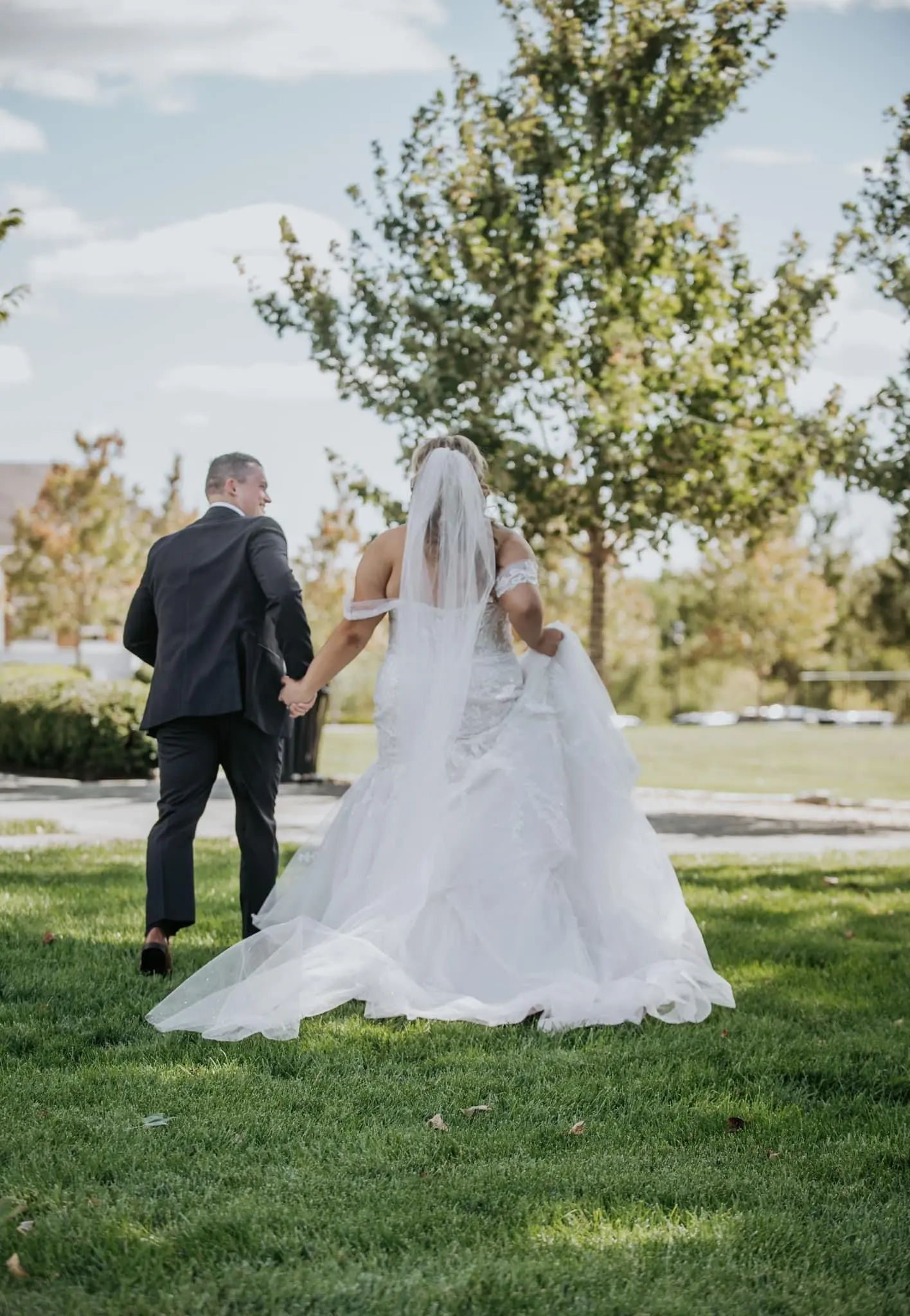 Bride wearing Danielle by Maggie Sottero walking with her husband