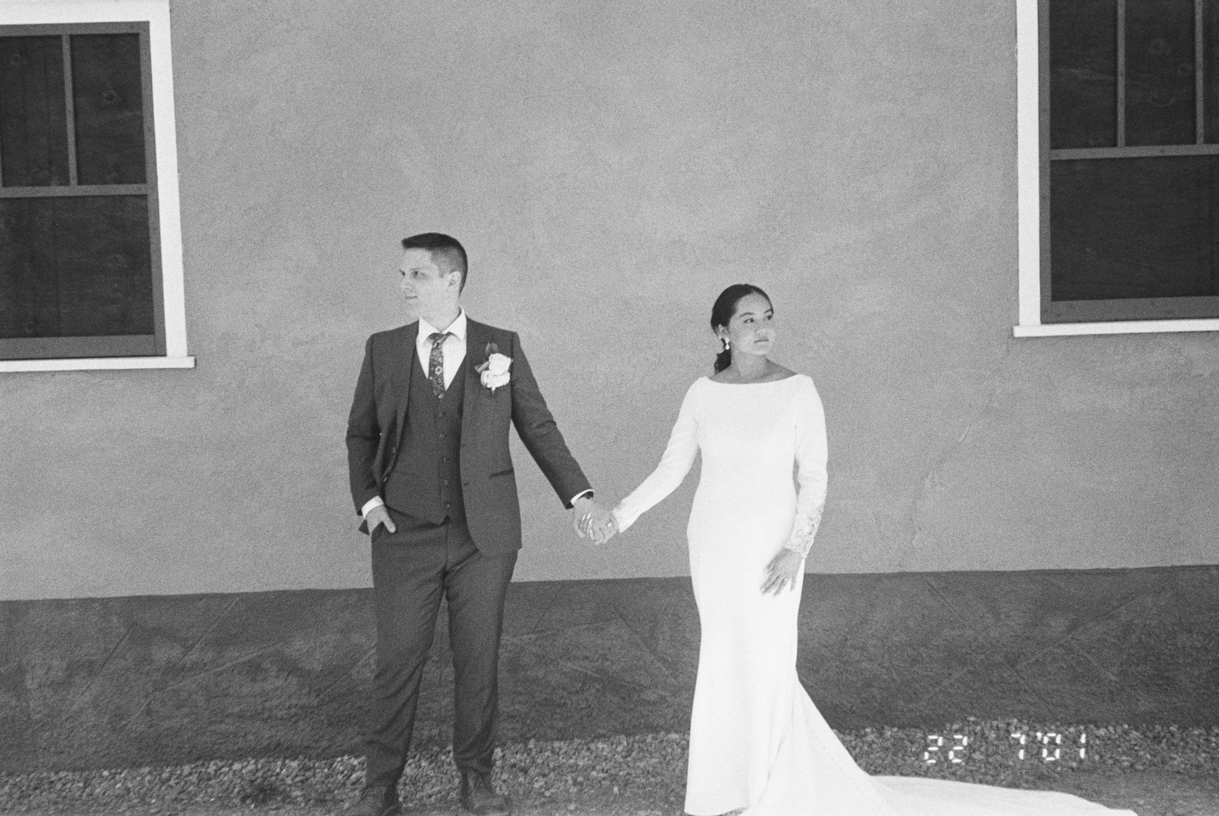 Bride wearing Aston by Sottero and Midgley holding hands with her husband
