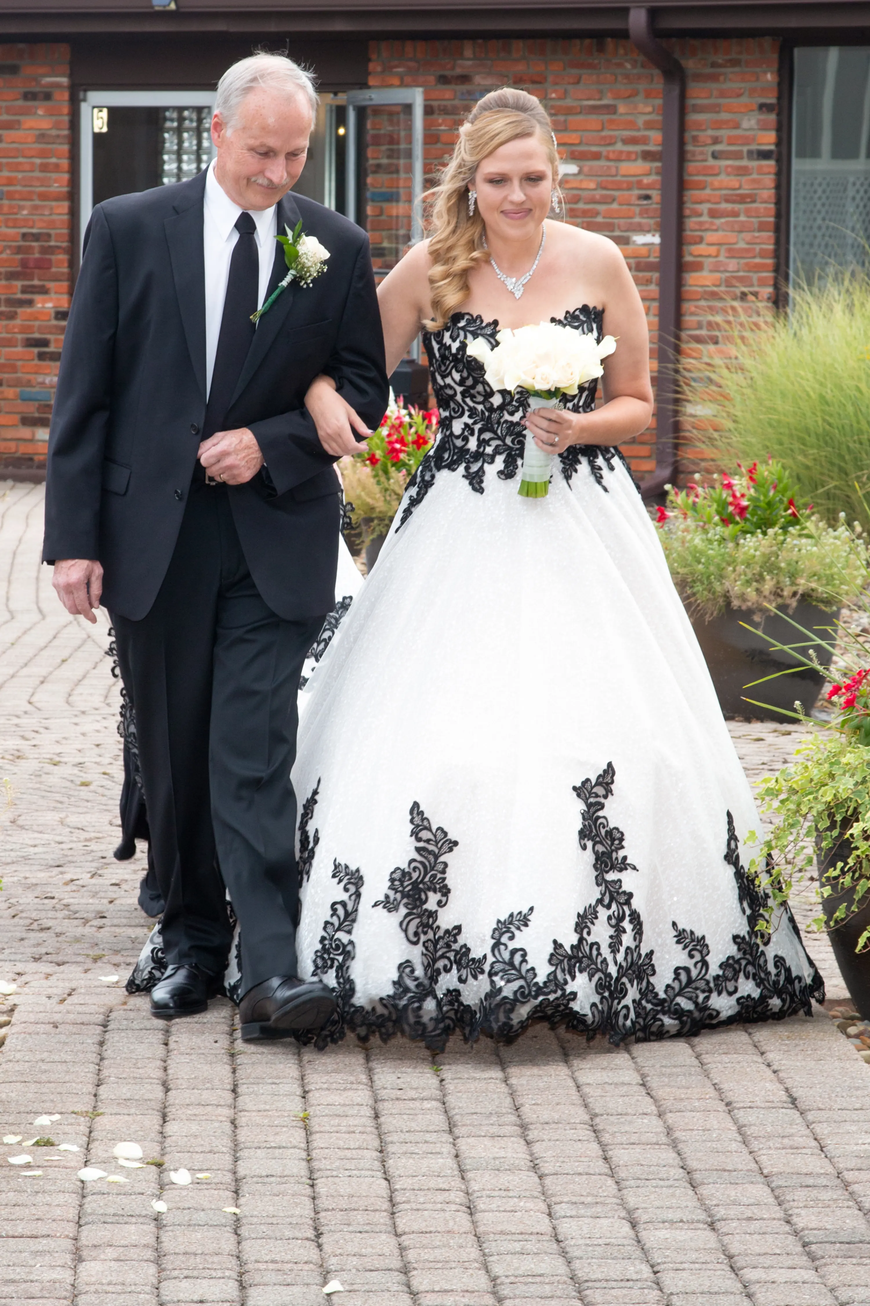Bride Wearing A-Line Black Lace Wedding Dress Called Tristyn By Maggie Sottero Walking Down the Aisle
