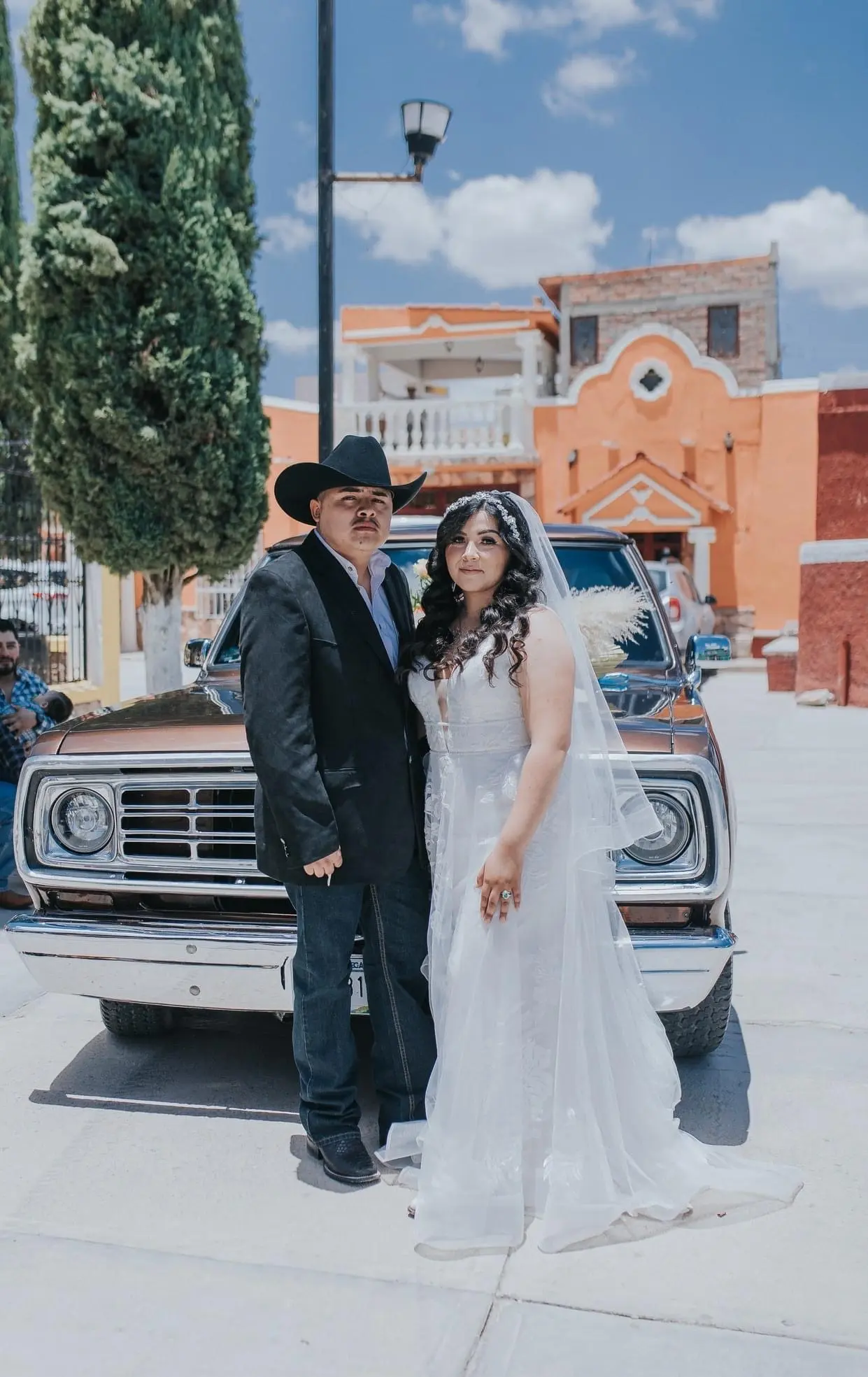Groom with Bride at Old Western Themed Wedding Wearing a Romantic Wedding Gown Called Priscilla by Rebecca Ingram.