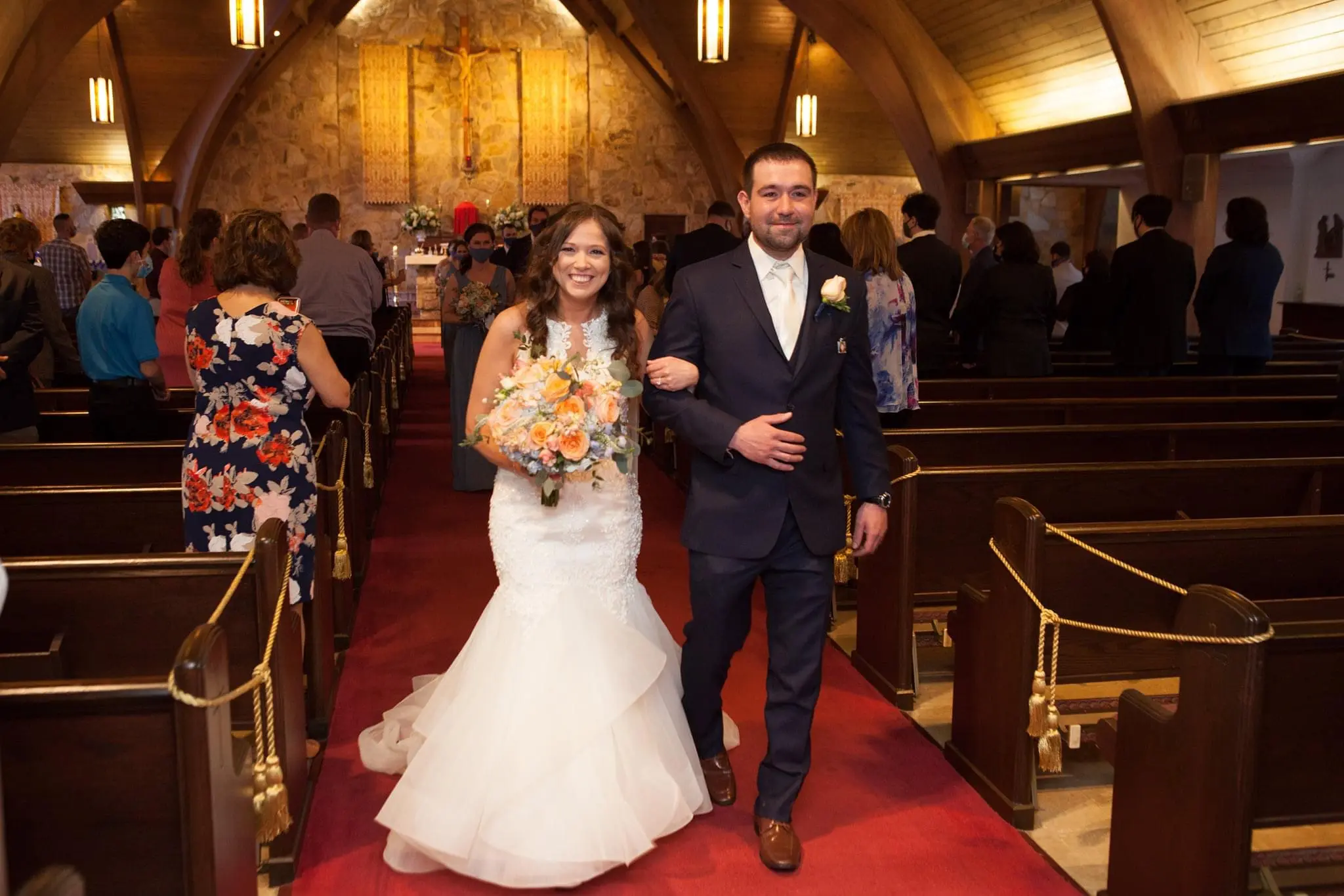 Bride with groom wearing organza mermaid wedding dress