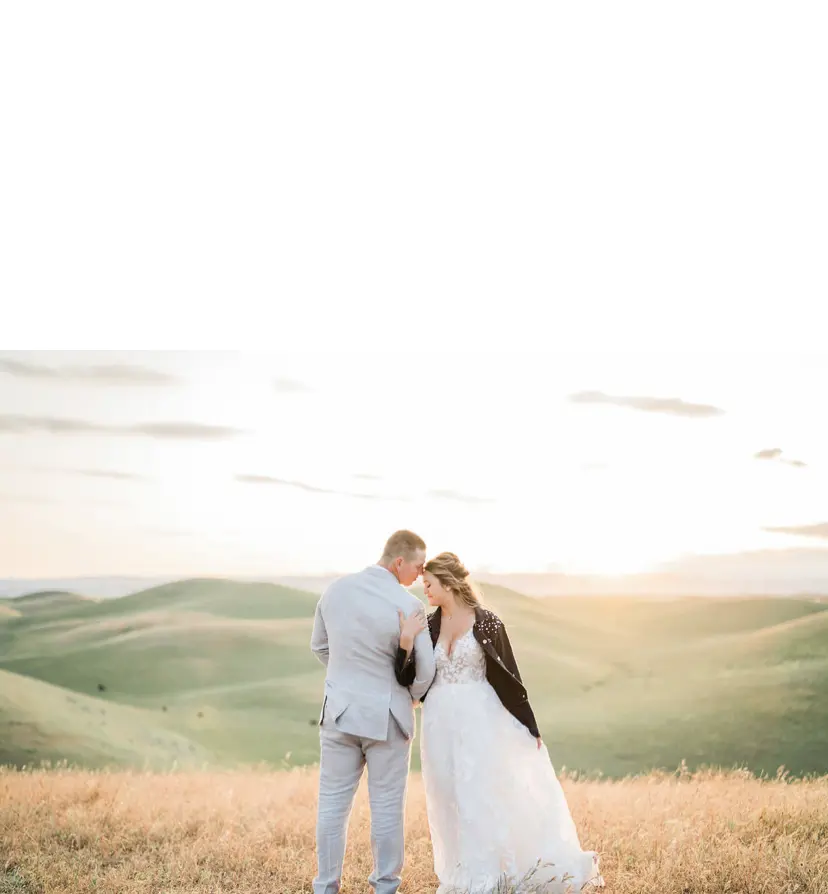 Groom Links Arms With Bride Wearing Winter Wedding Dress by Maggie Sottero
