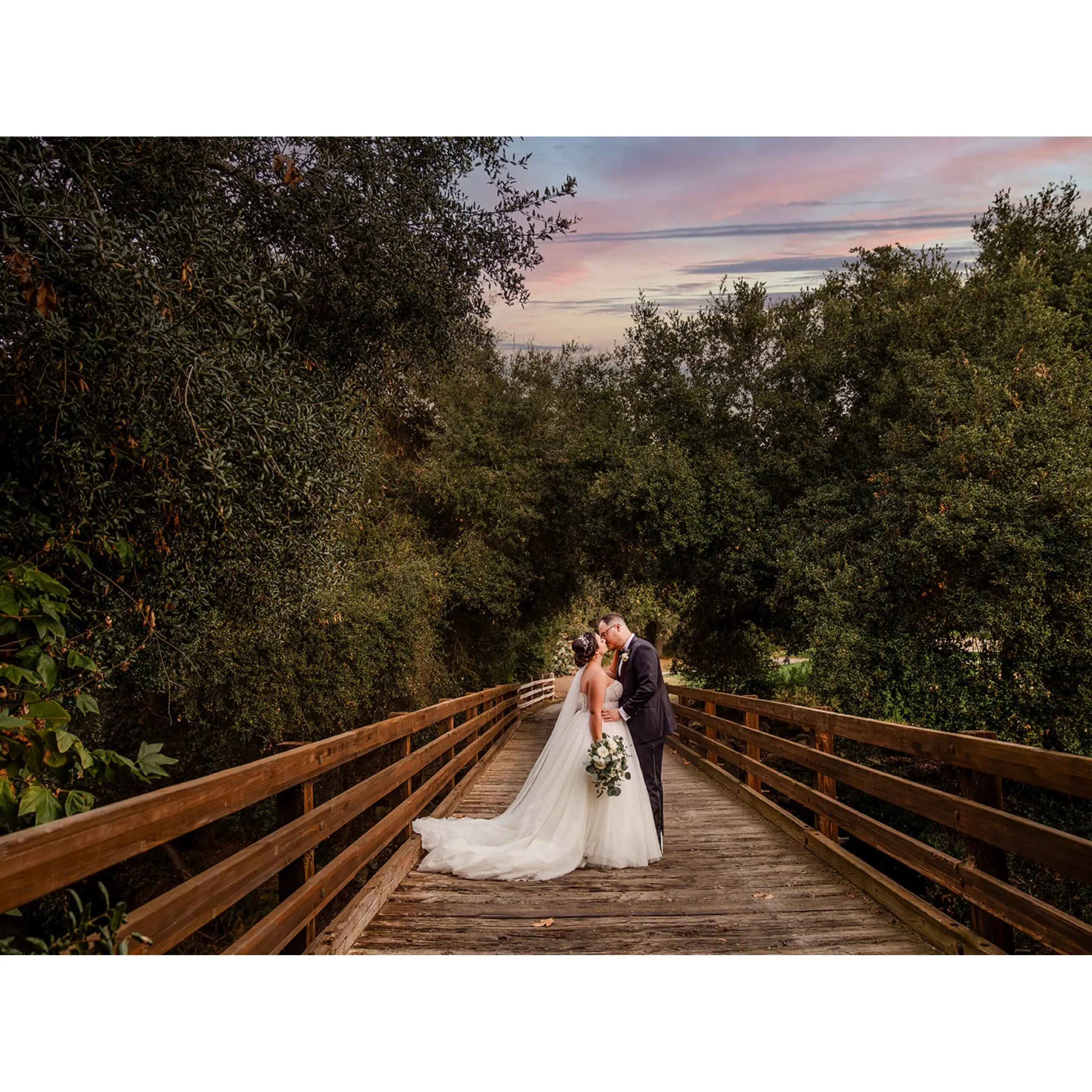 Bride wearing Elton wedding dress by Sottero and Midgley kissing her husband