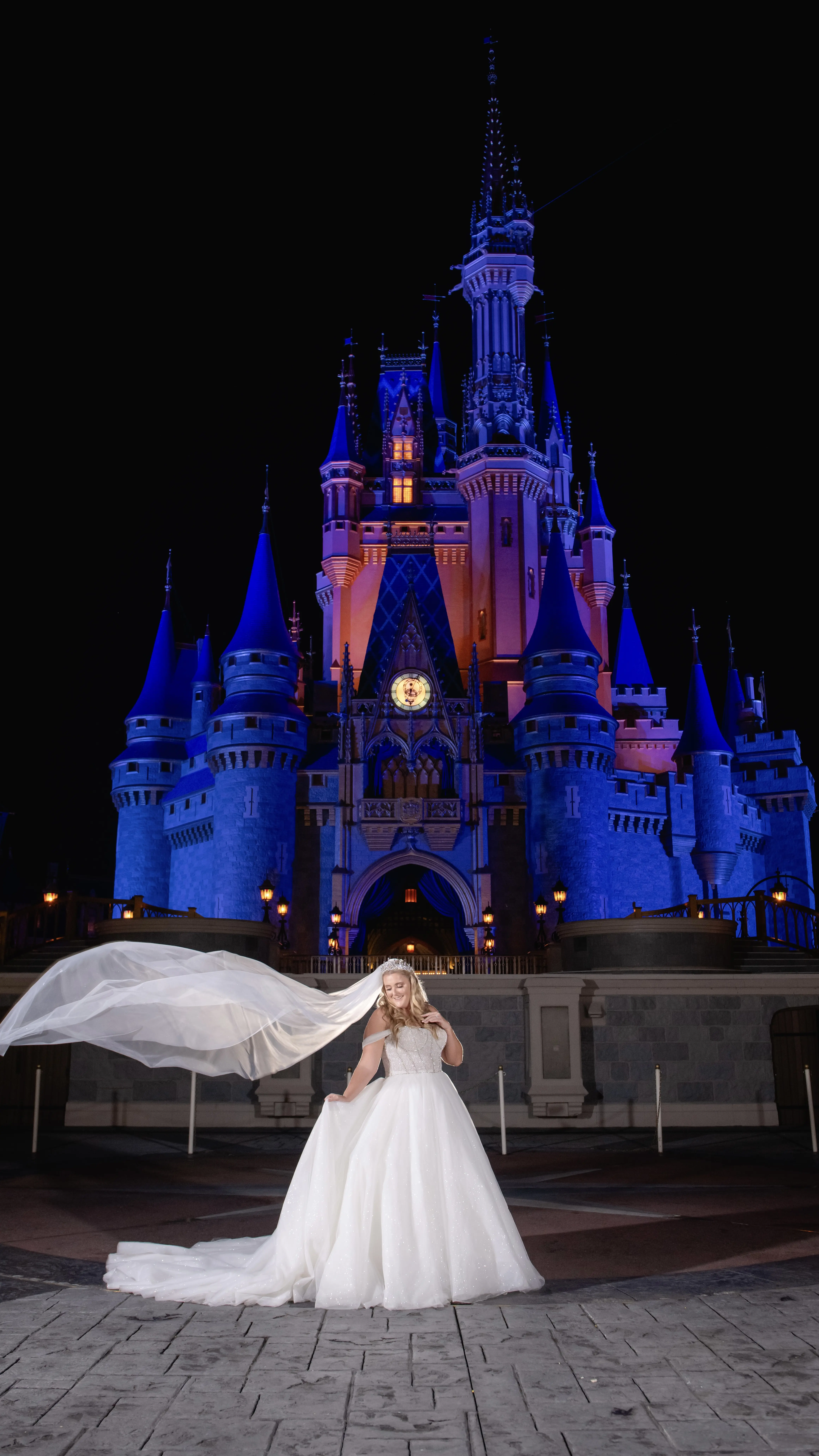 Bride wearing Elton wedding dress by Sottero and Midgley om front of Disney castle