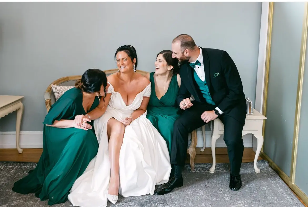 Bride wearing Ekaterina by Maggie Sottero laughing with her bridal party