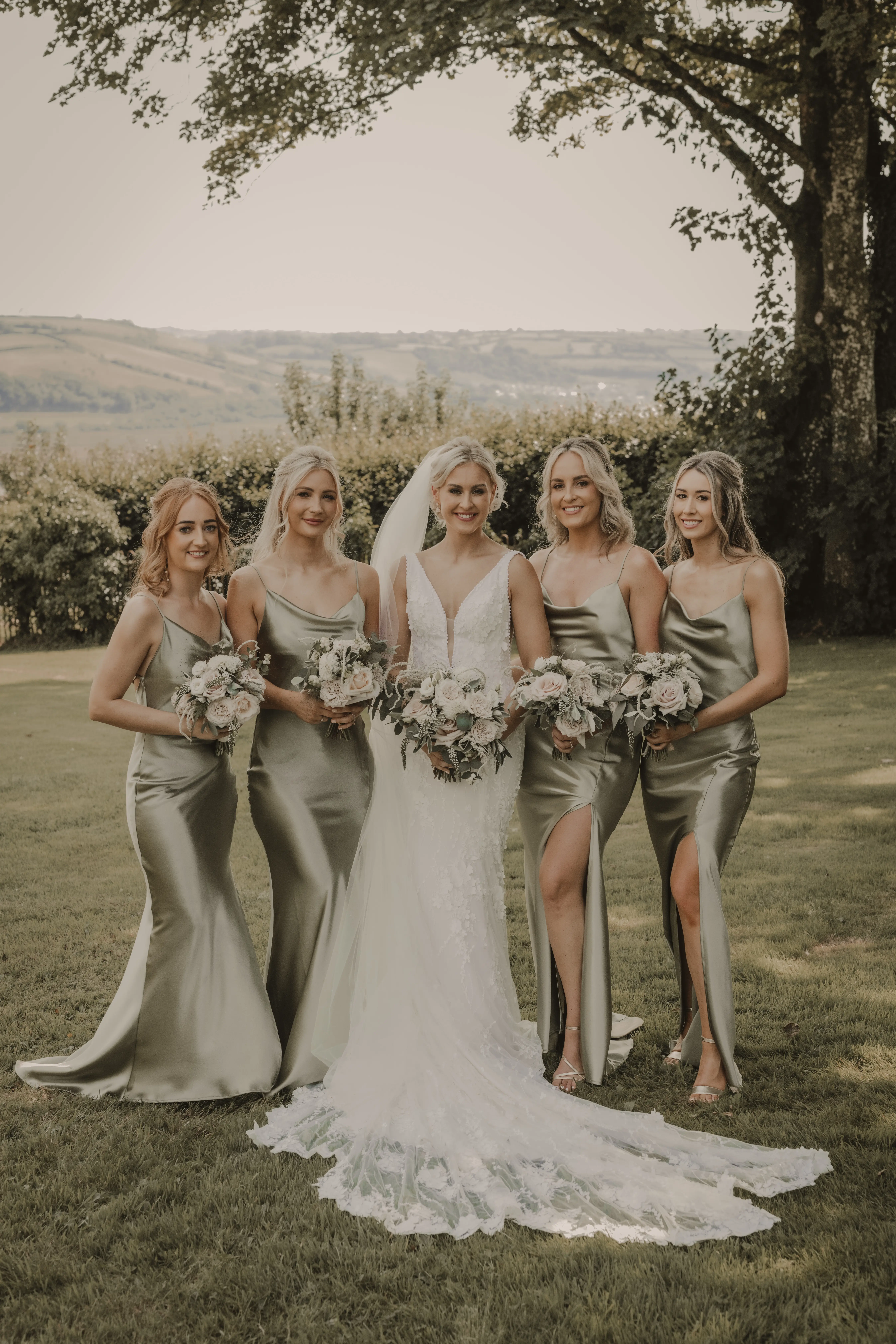 Bridal Party with Bride in Vintage-Inspired Mermaid Wedding Dress with 3-D Floral Motifs and Extended Scalloped Lace Train Called Cruz by Sottero & Midgley