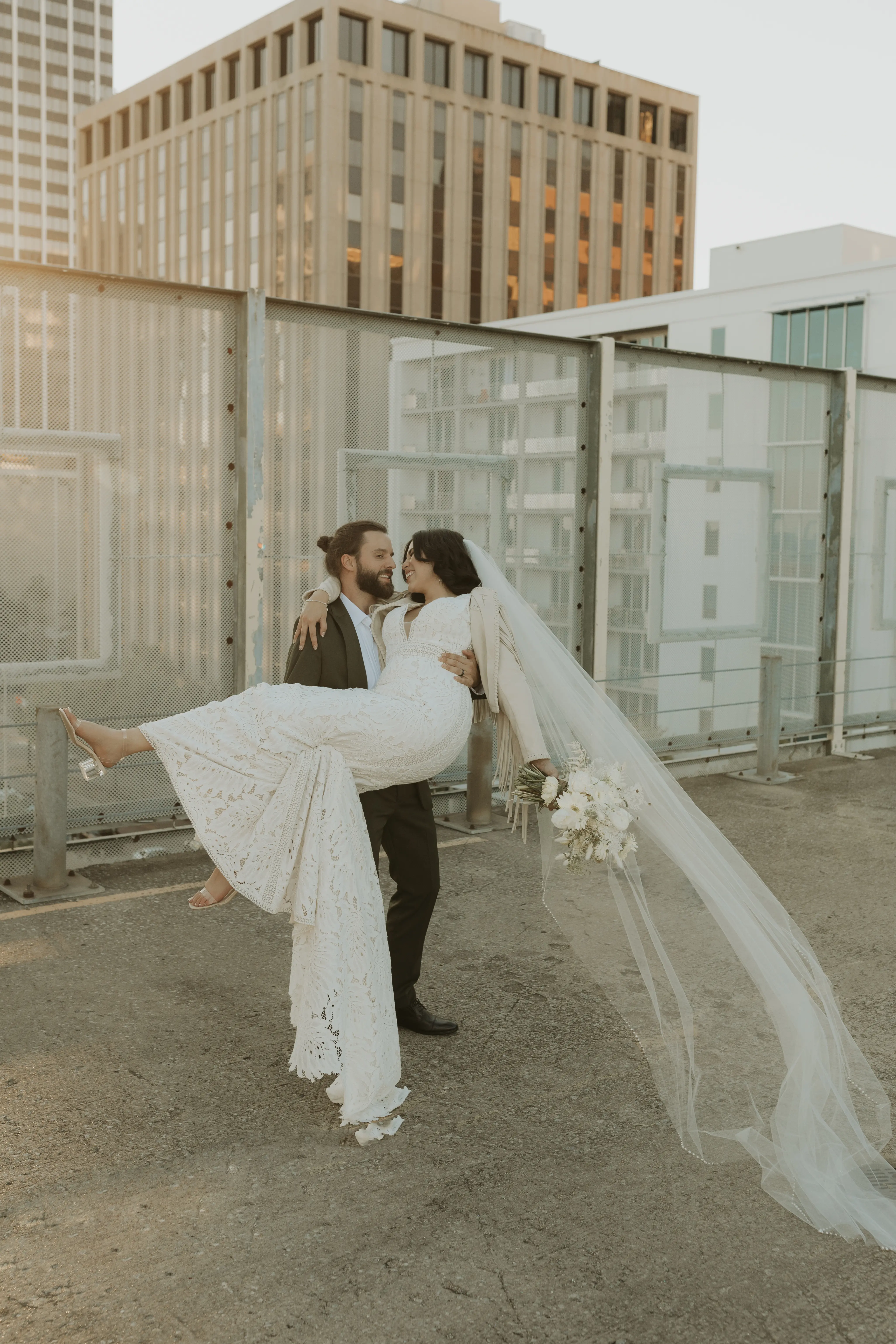 Groom carrying his bride wearing wedding dress called Burke.