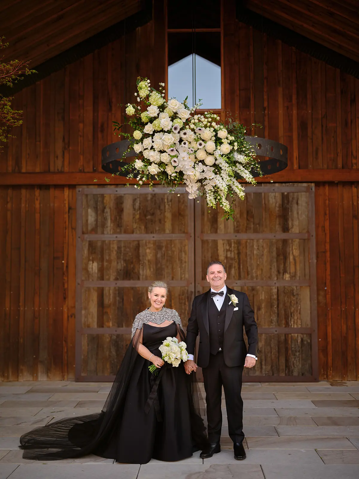 Bride wearing Aspen by Sottero and Midgley standing with her husband