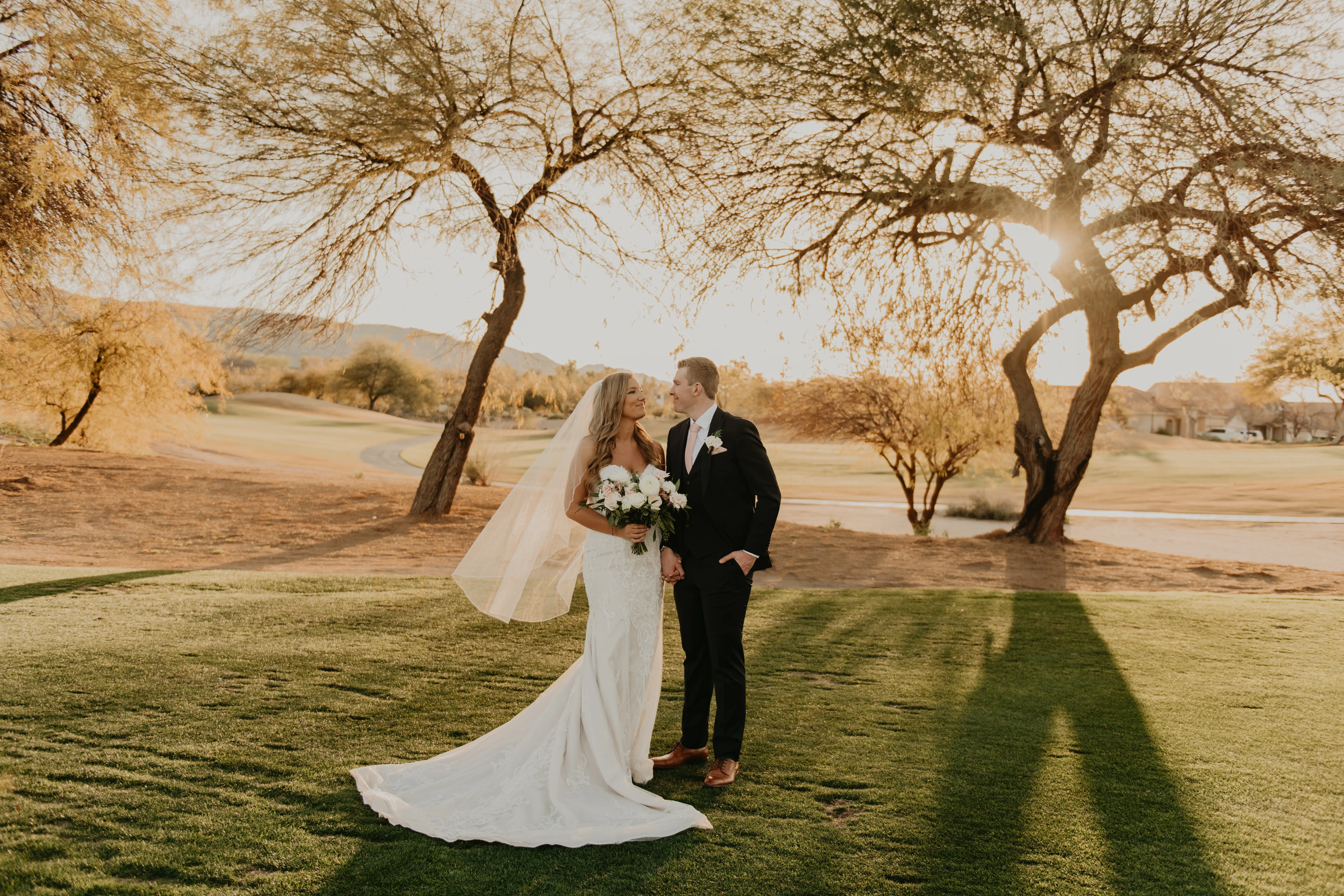 Groom Holds Hand of Bride Wearing Detailed Elegant Strapless Wedding Dress Frederique by Maggie Sottero