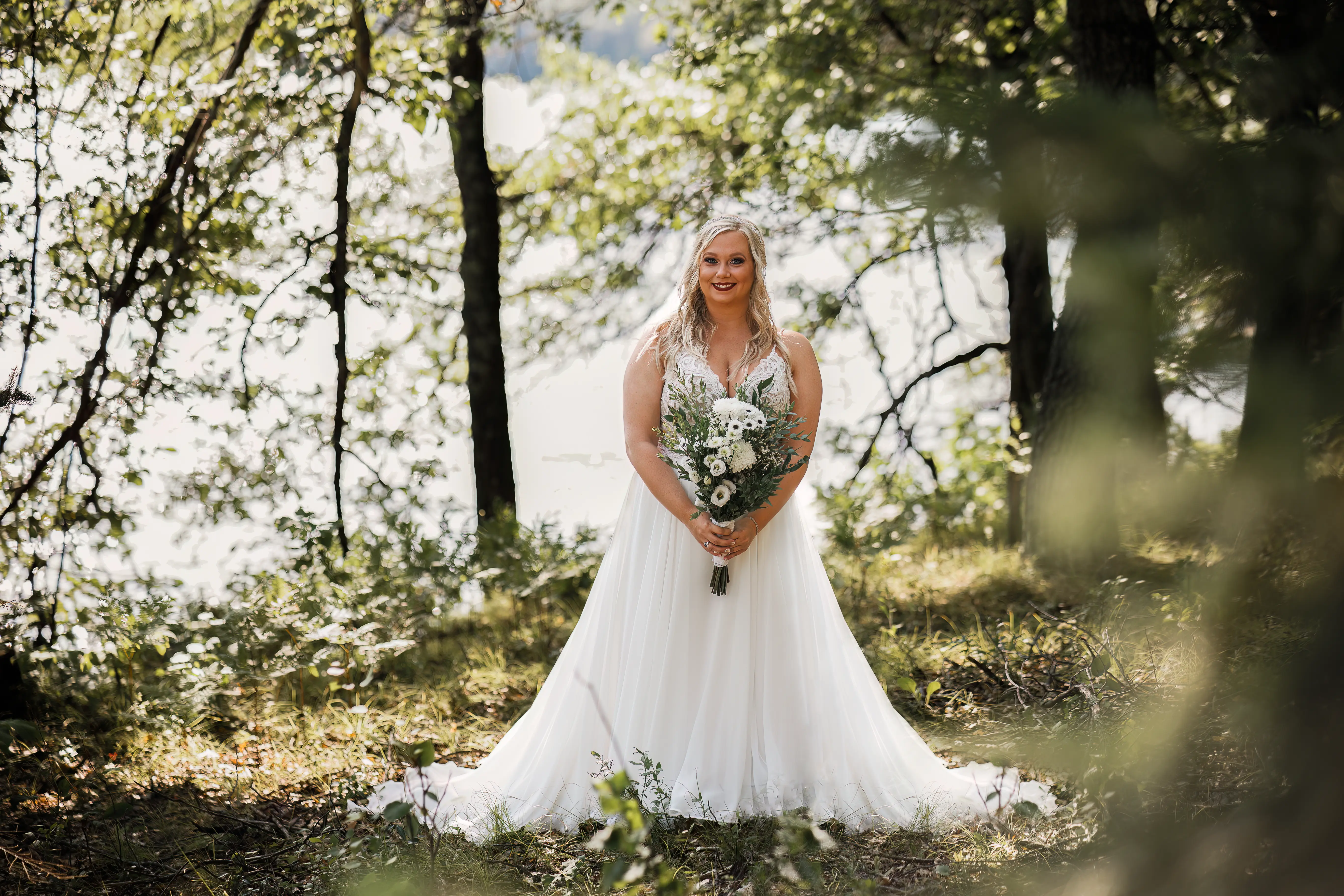 Bride Wearing Beaded Wedding Dress With Flowy Skirt Called Lorraine By Rebecca Ingram Holding Floral Bouquet