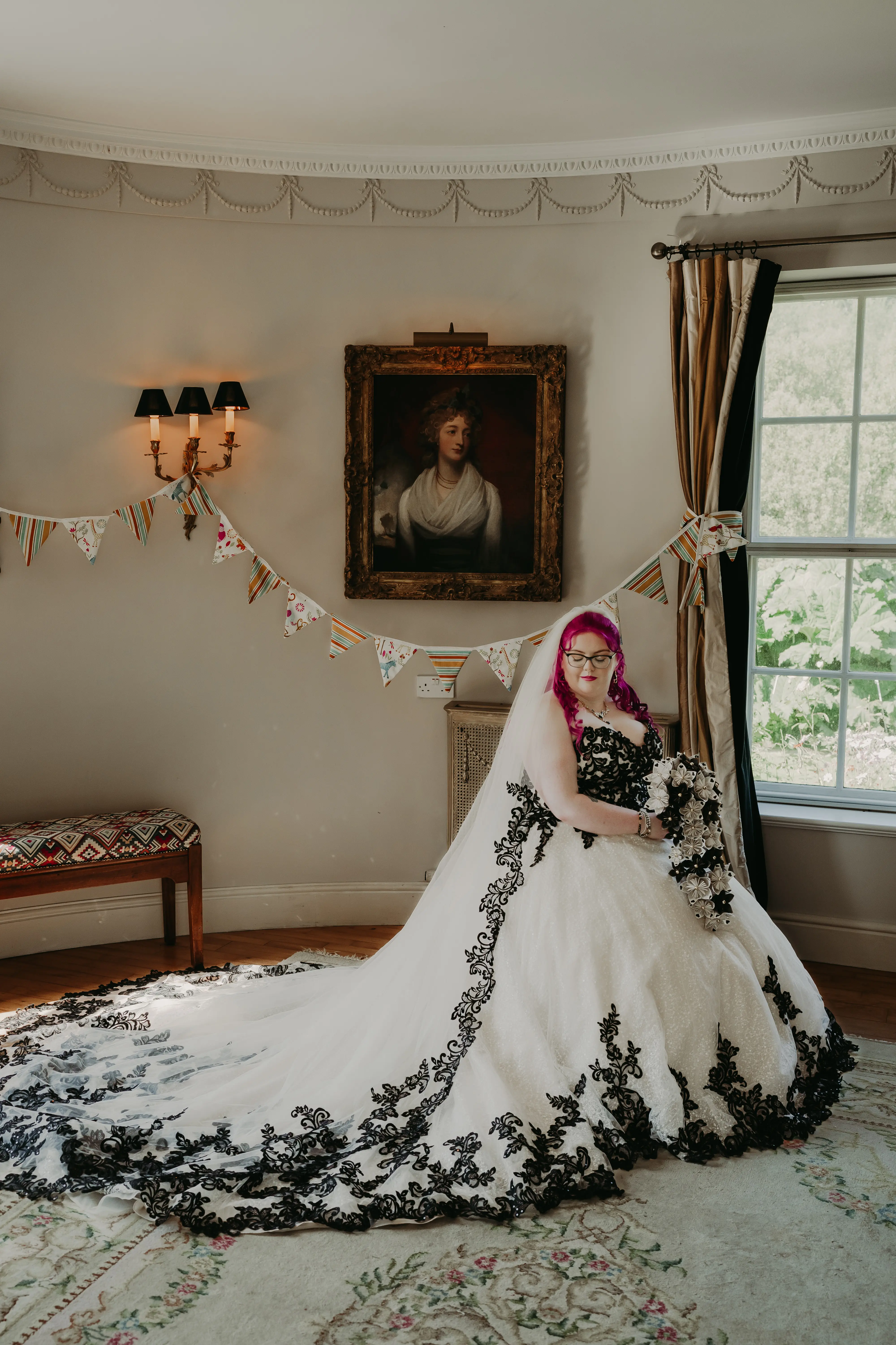 Bride Wearing Gothic Black Lace Wedding Dress Called Tristyn By Maggie Sottero Holding Black and White Floral Bouquet