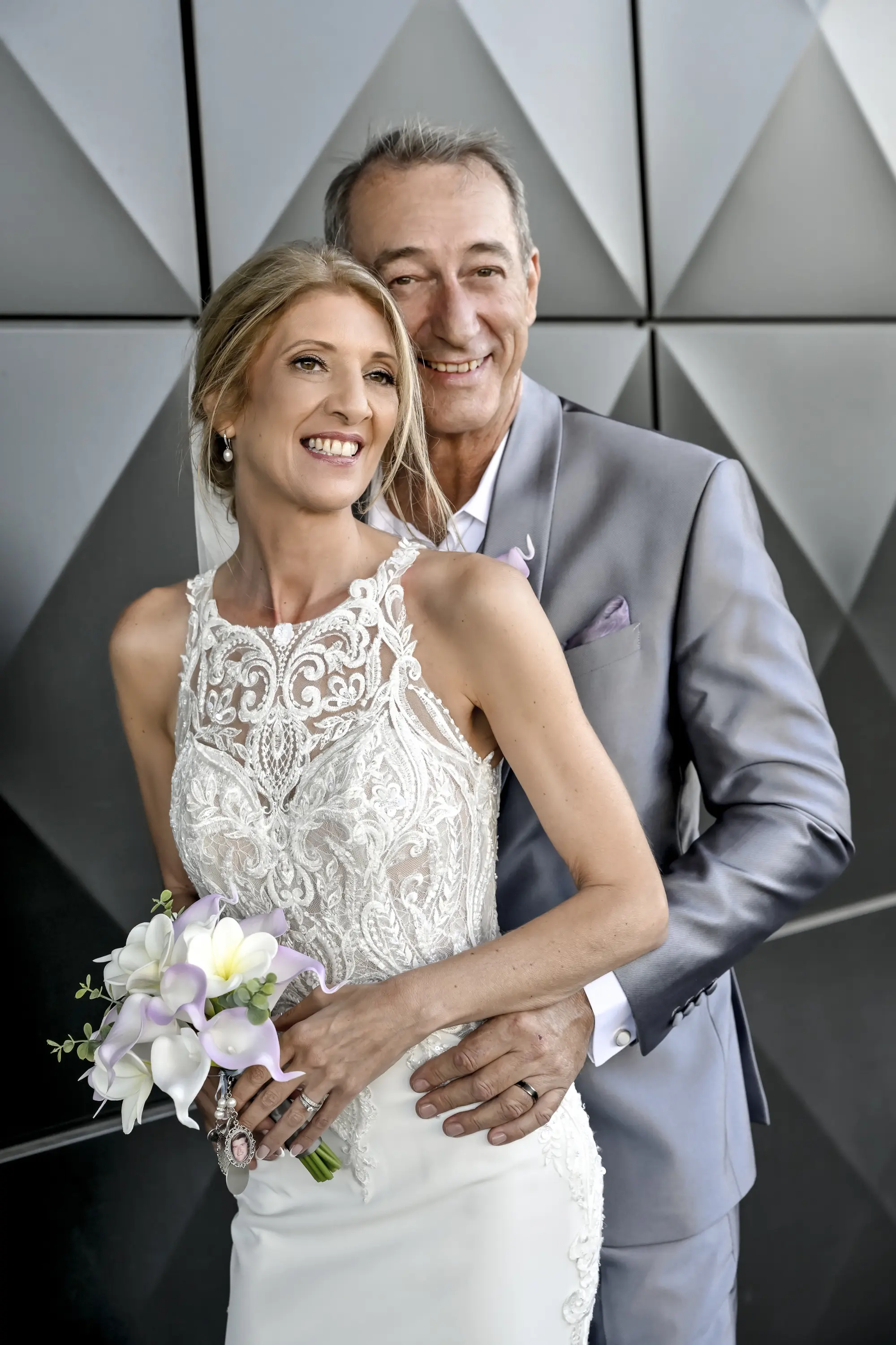 Bride wearing Audrina by Maggie Sottero being held by her husband