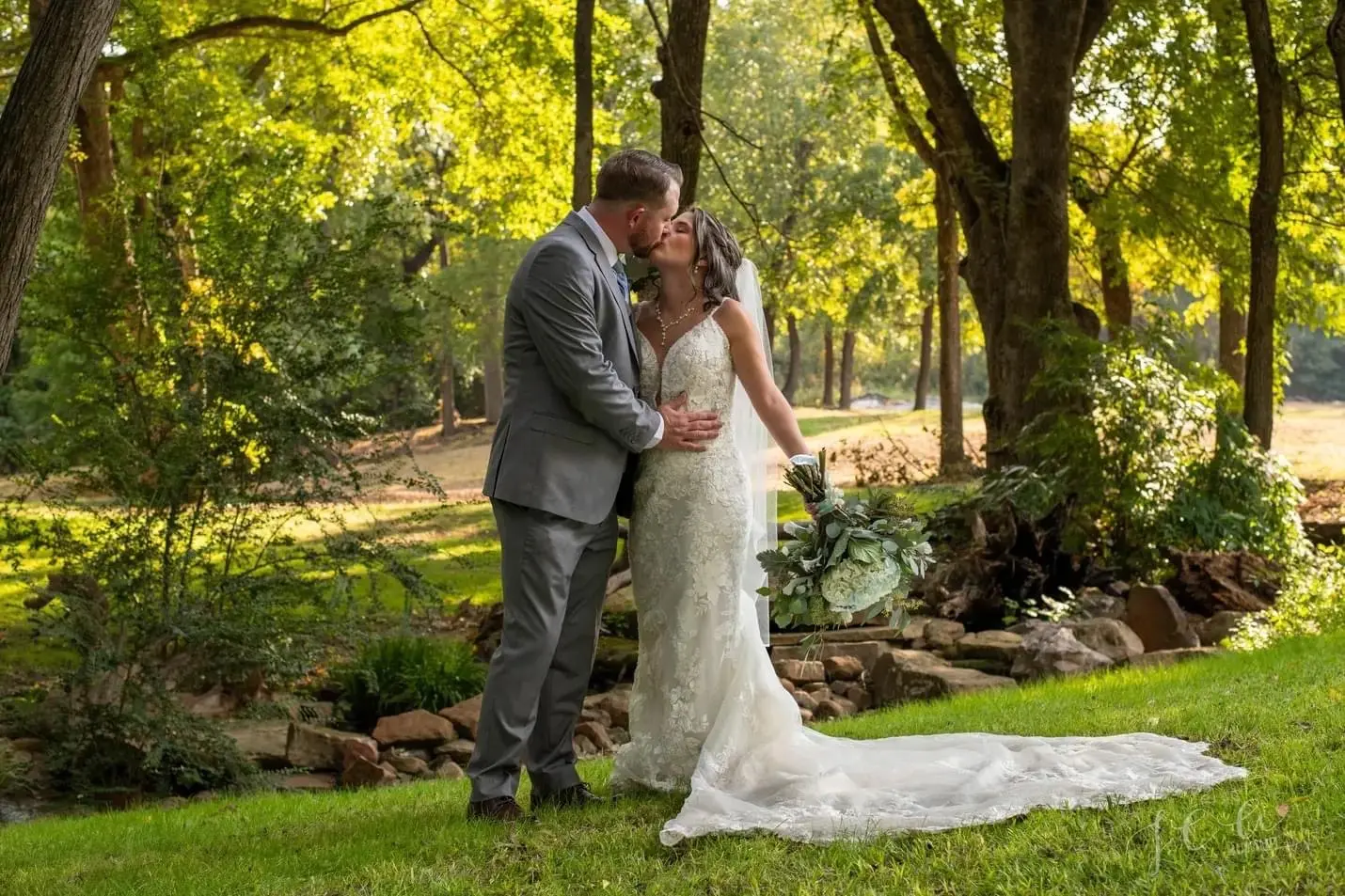 Groom Kissing Bride in Vintage-Inspired Fitted Wedding Dress with Plunging Neckline called Veronique by Maggie Sottero
