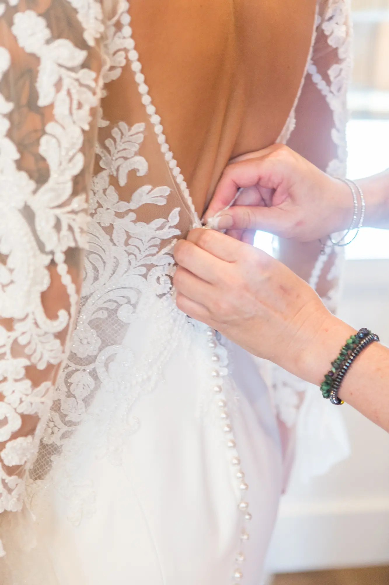 Bride Wearing Lace Mermaid Wedding Gown Called Nikki By Maggie Sottero Buttoning Up The Dress