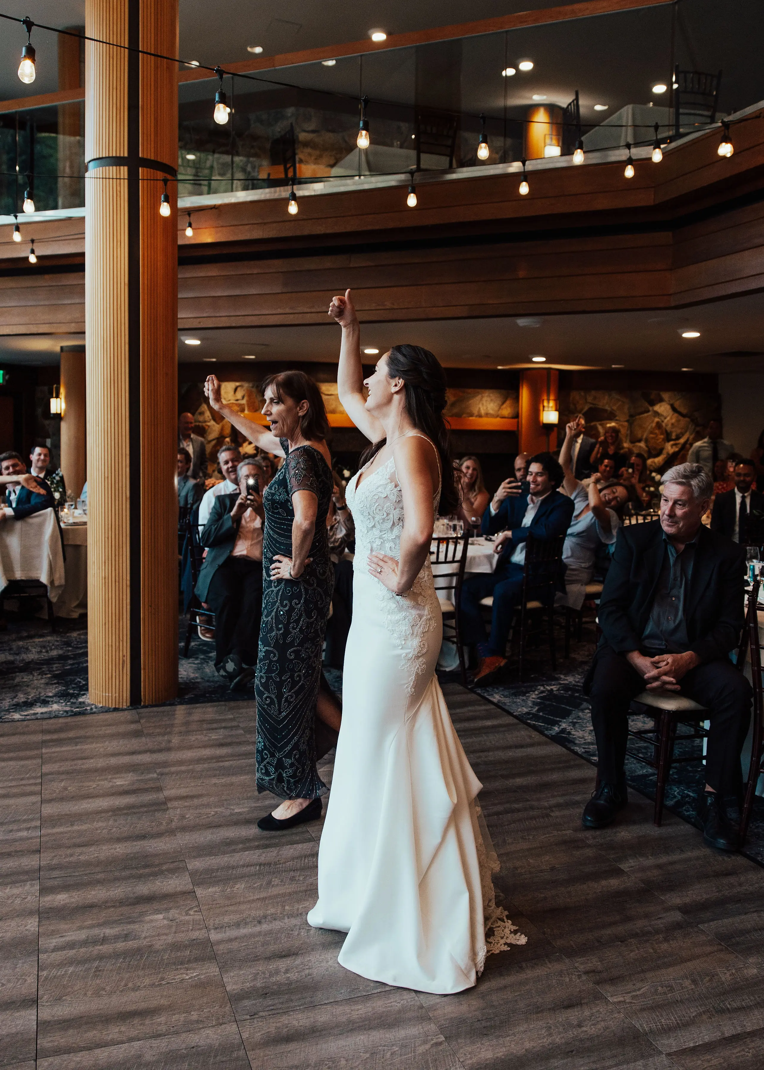 Bride Wearing Lace Mermaid Wedding Dress Indoors on Dance Floor.