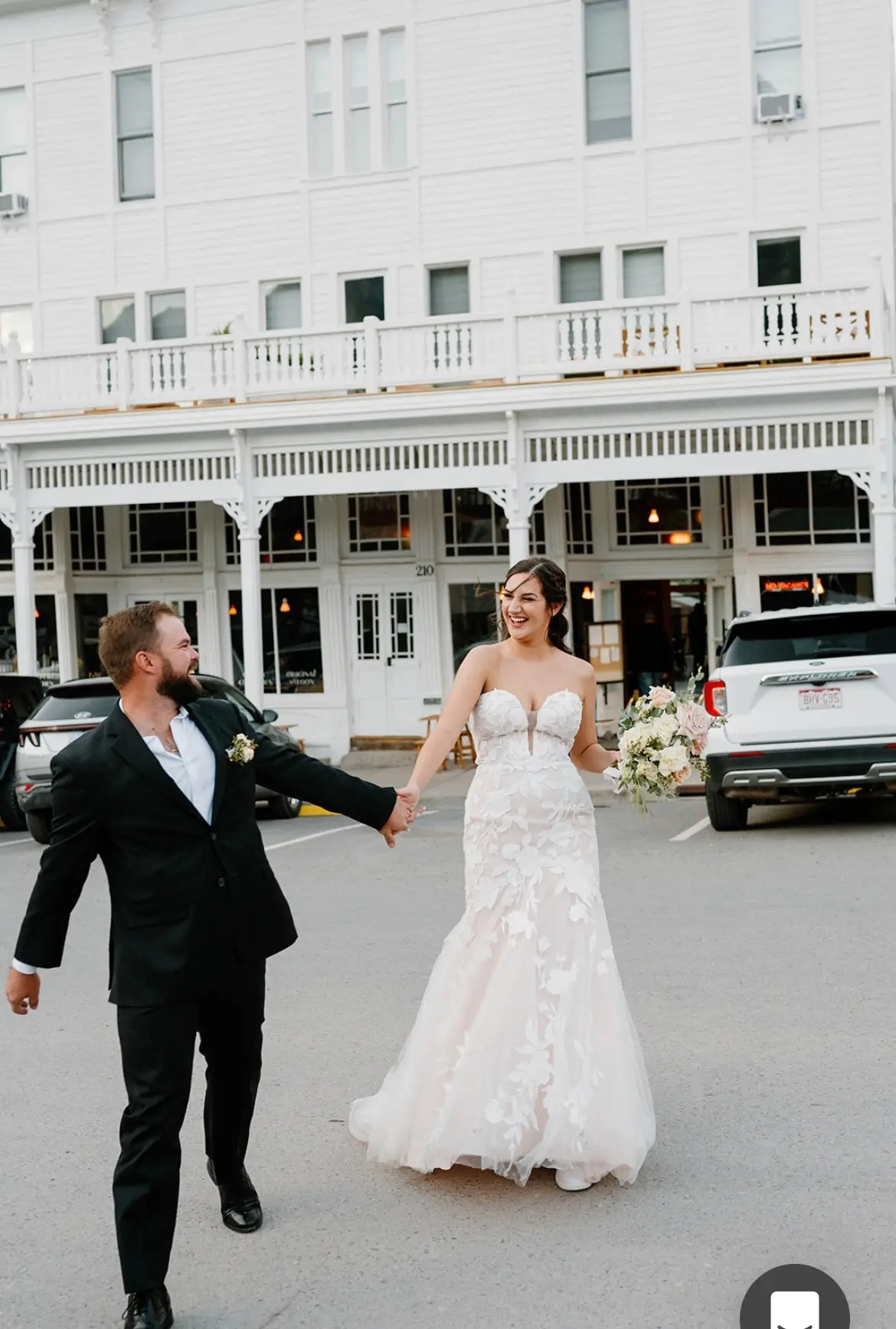 Bride wearing Hattie wedding dress by Rebecca Ingram walking with her husband