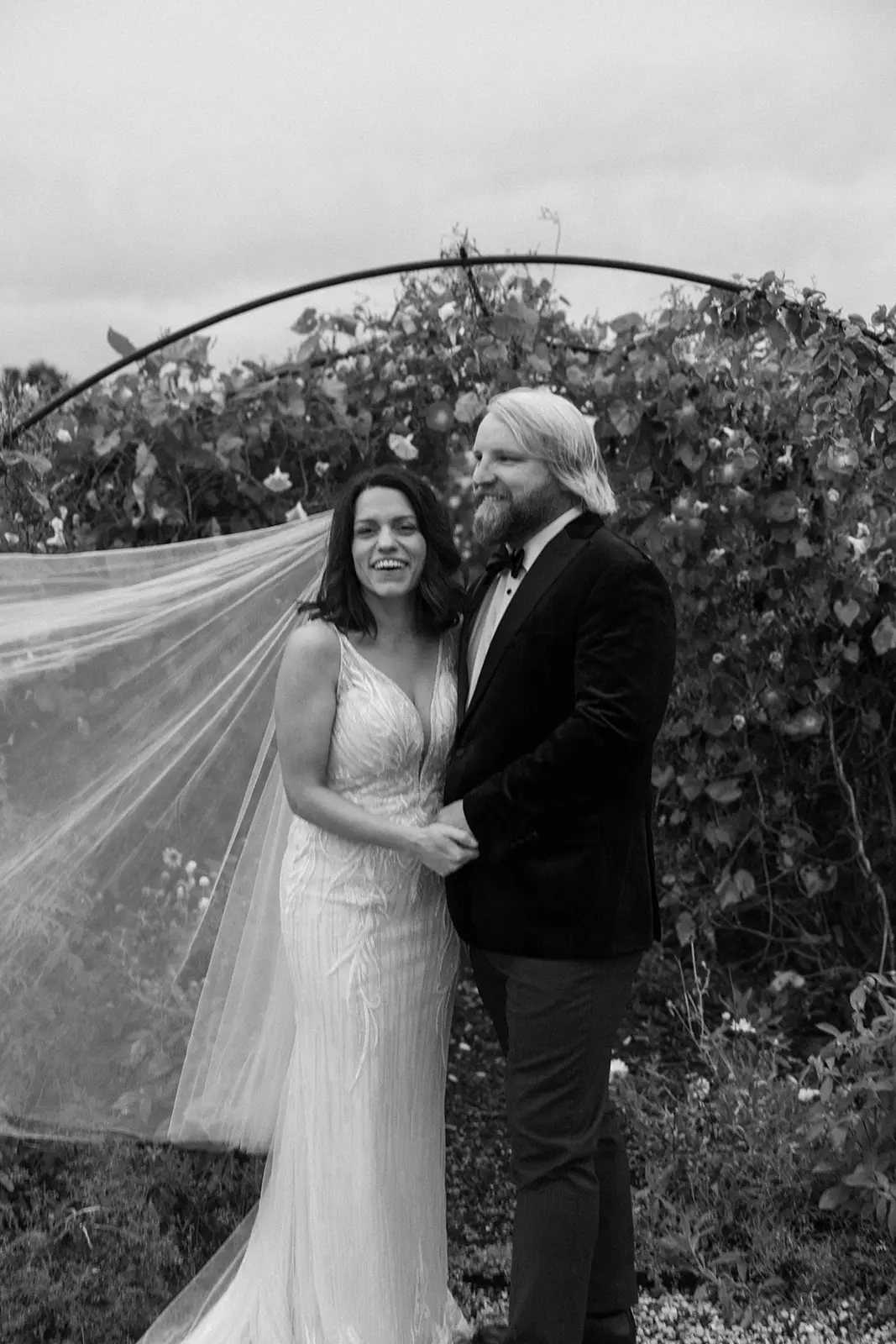 Bride wearing Luella wedding dress by Sottero and Midgley smiling with her husband