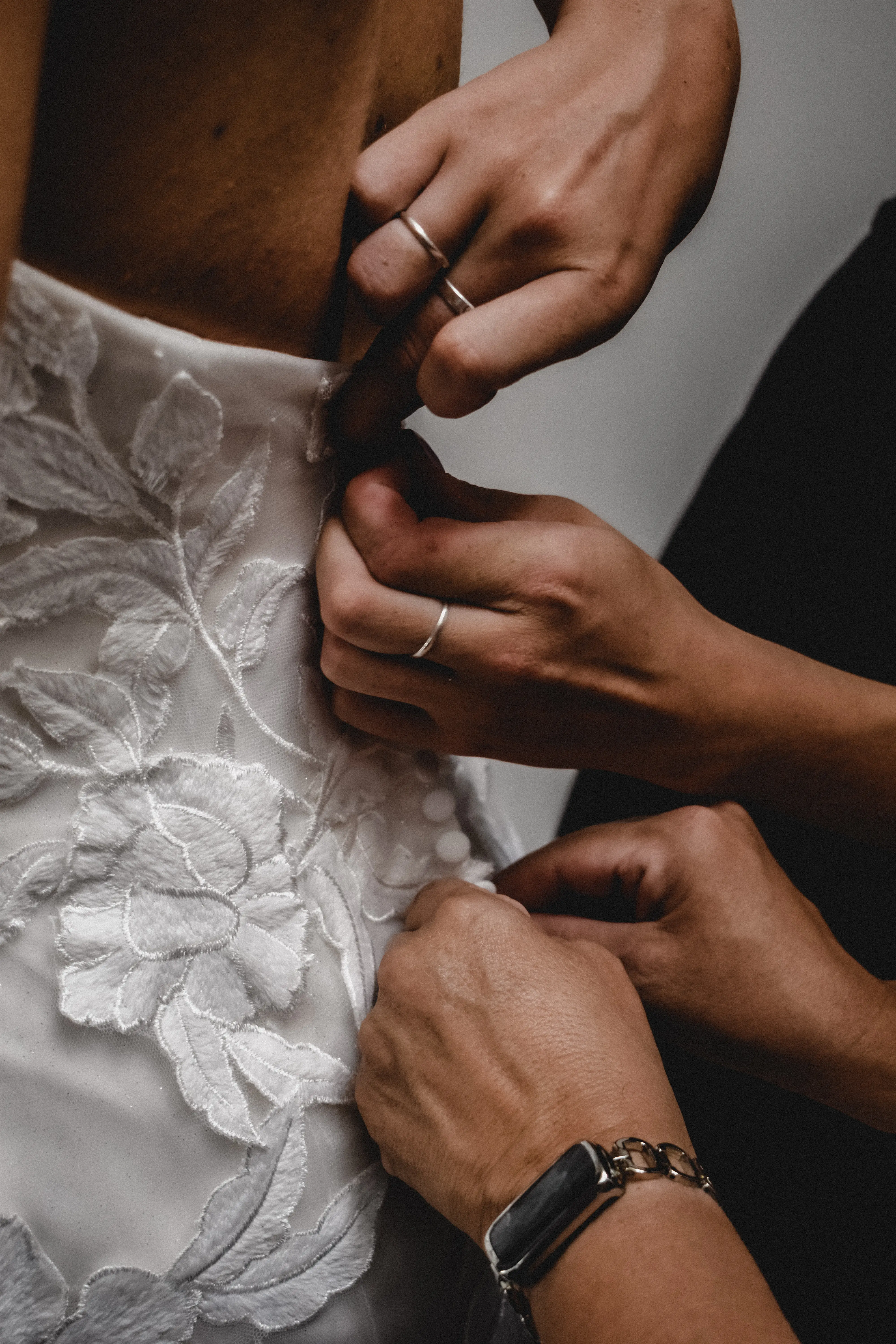 Bride Wearing Lace Mermaid Wedding Dress Called Hattie By Rebecca Ingram Buttoning Up The Dress