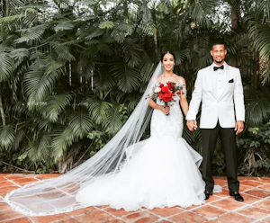 Bride with groom wearing glamorous mermaid wedding dress