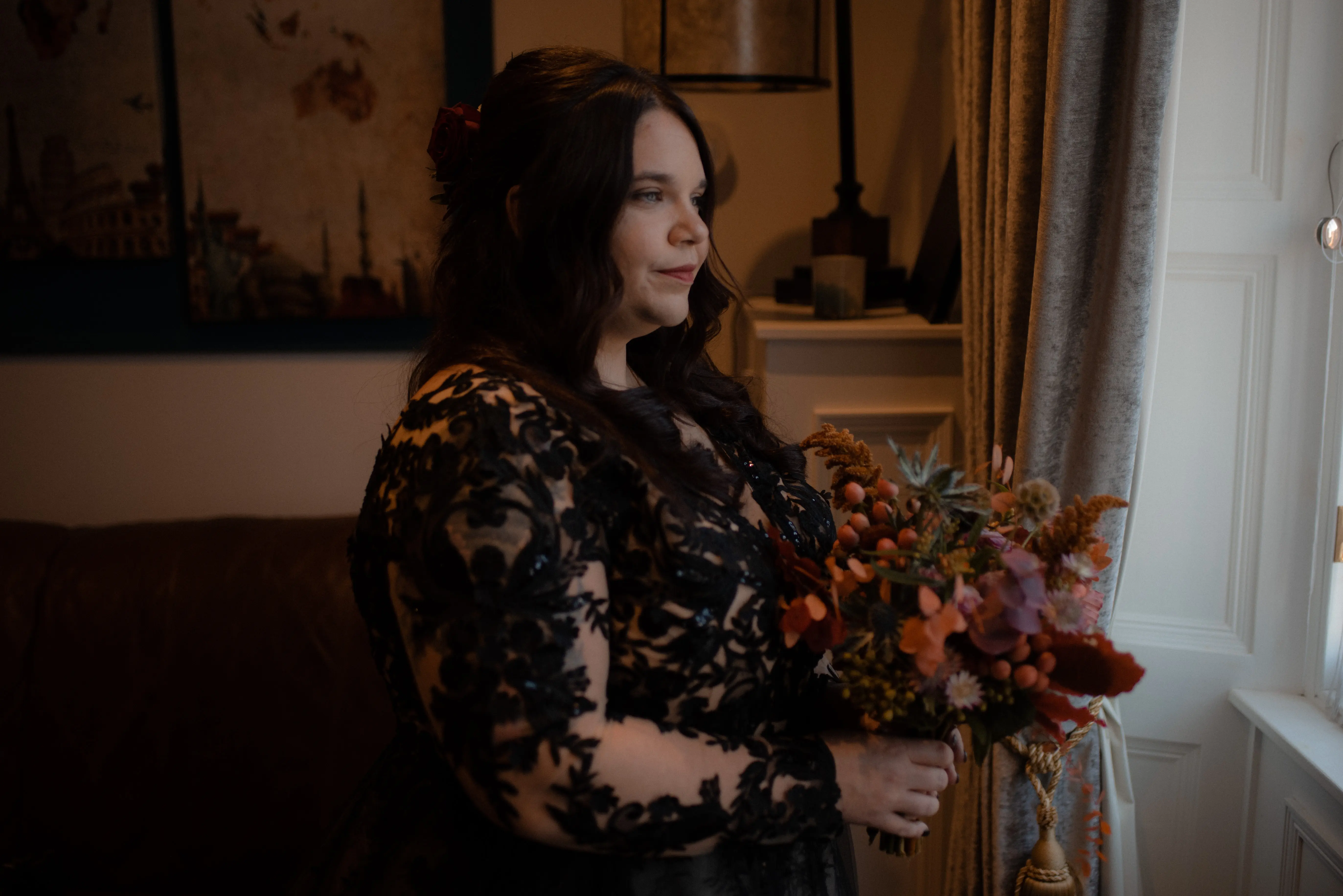 Bride Wearing Black A-Line Wedding Dress Called Zander By Sottero And Midgley Looking Out A Window