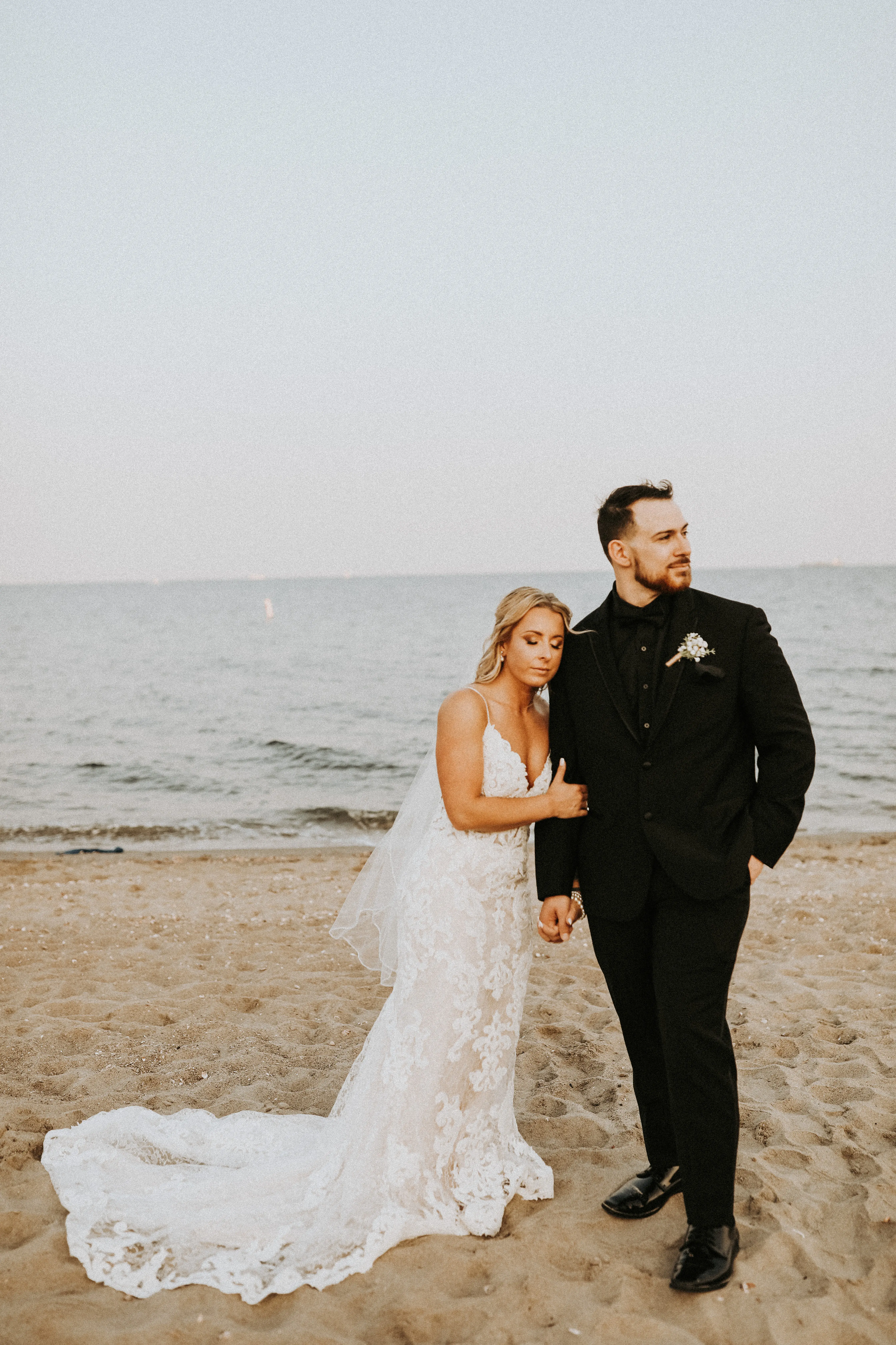 Bride In Lace Sheath Wedding Gown Name Tuscany Lynette By Maggie Sottero Bride And Groom On Beach
