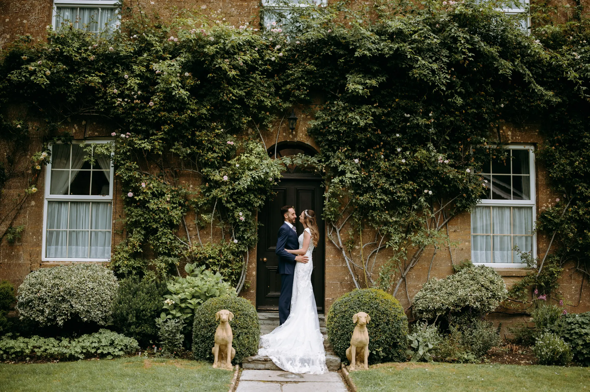 Newlyweds facing each other smiling. Bride wearing wedding dress called Celeste.