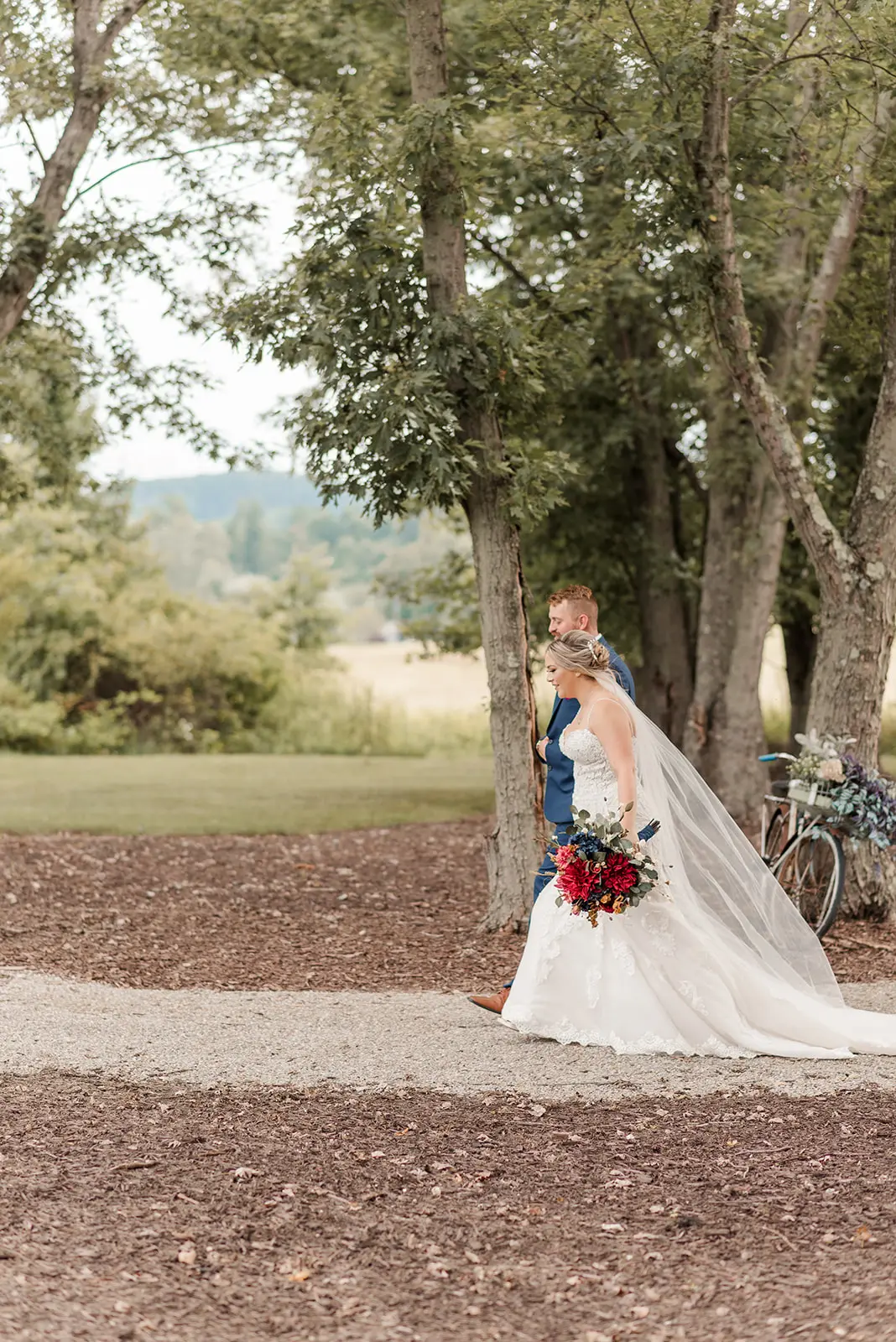Bride Wearing Sexy Mermaid Lace Wedding Dress Called Fiona By Maggie Sottero Walking With Groom In A Park