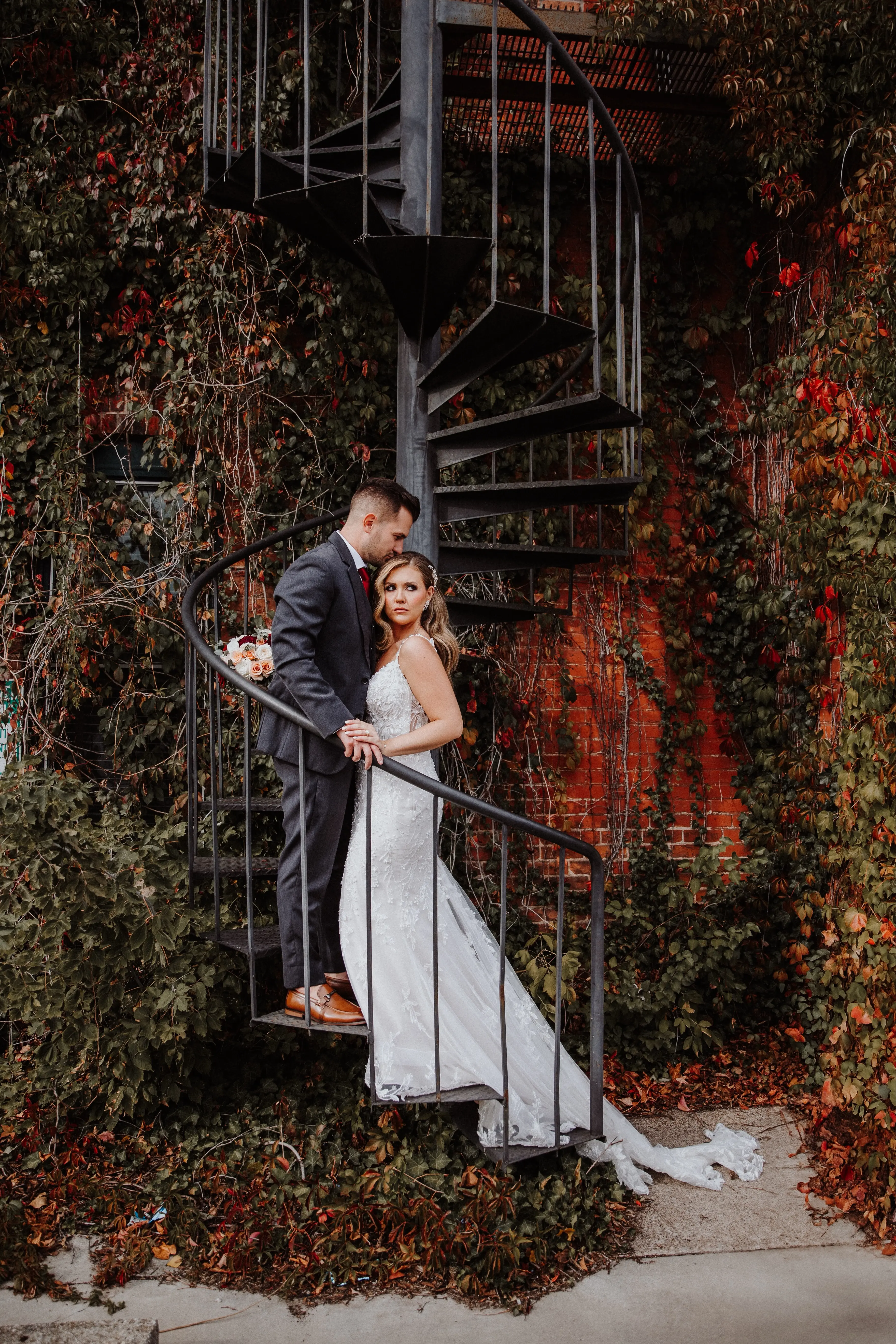 Bride Wearing Beaded Fit-n-flare Wedding Dress Called Jonah Lane By Sottero And Midgley With Groom On A Staircase