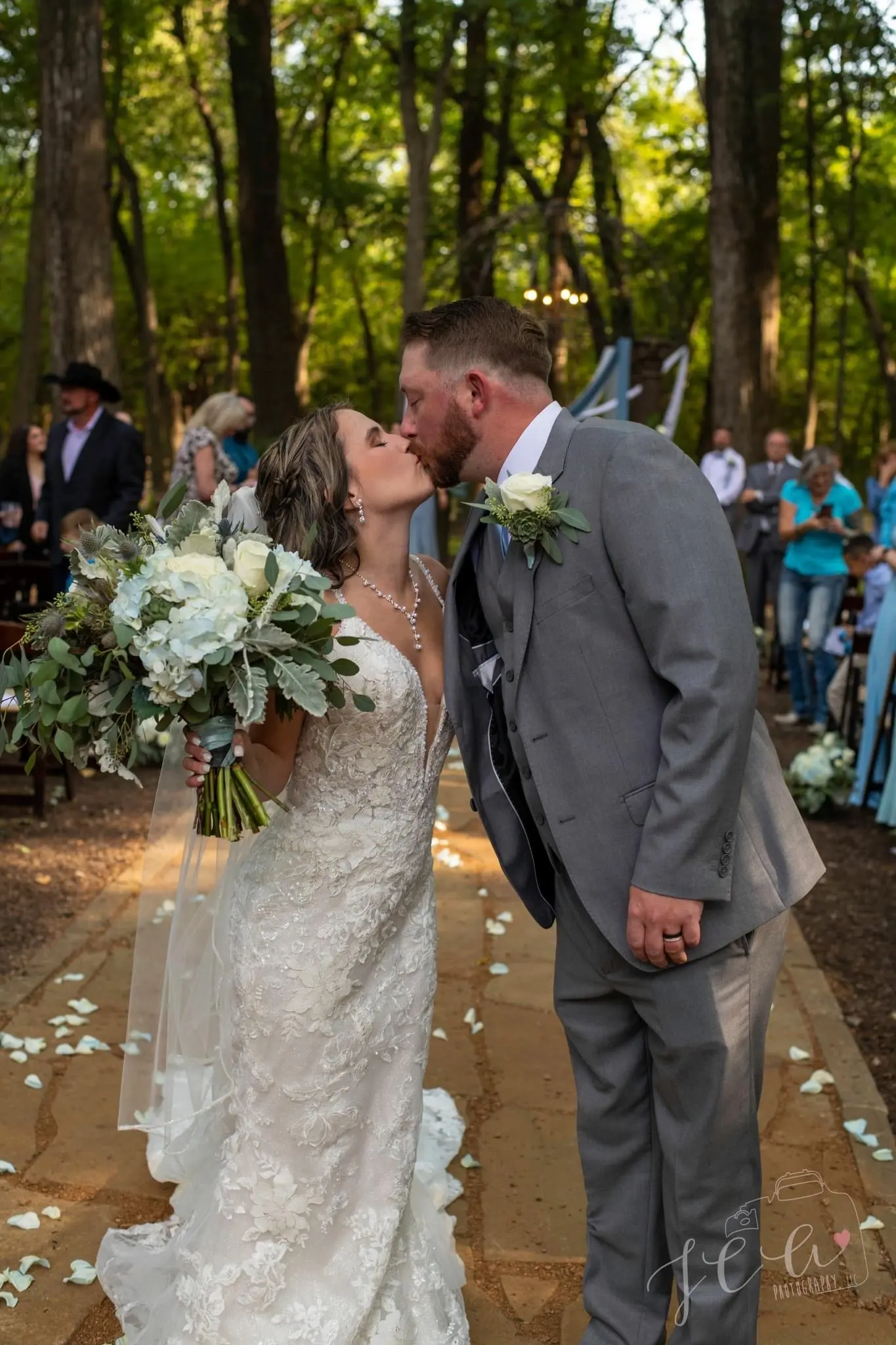 Groom Kissing Bride in Vintage-Inspired Fitted Wedding Dress with Plunging Neckline called Veronique by Maggie Sottero