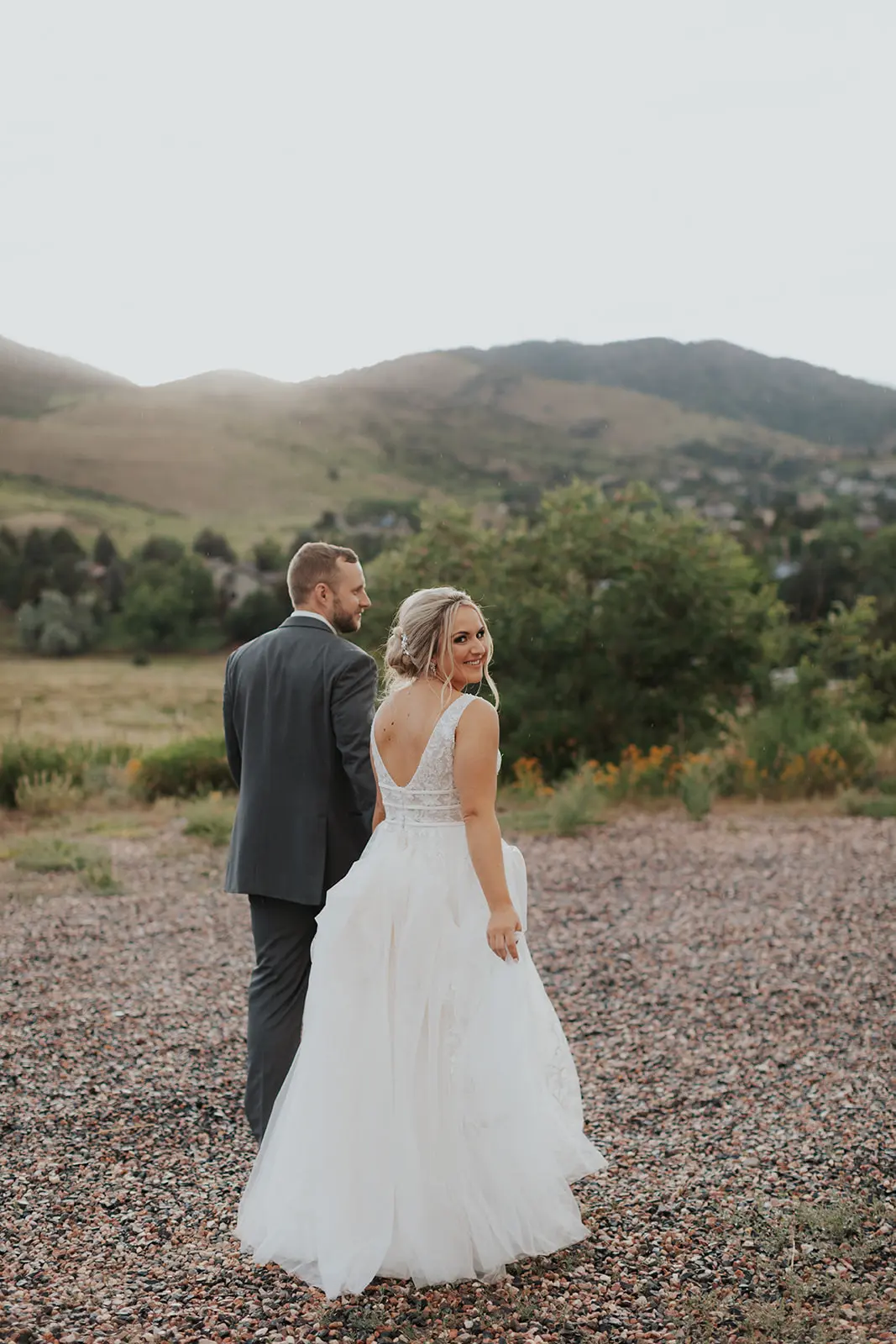 Bride In Lace Backless Wedding Dress Called Raelynn By Rebecca Ingram With Groom