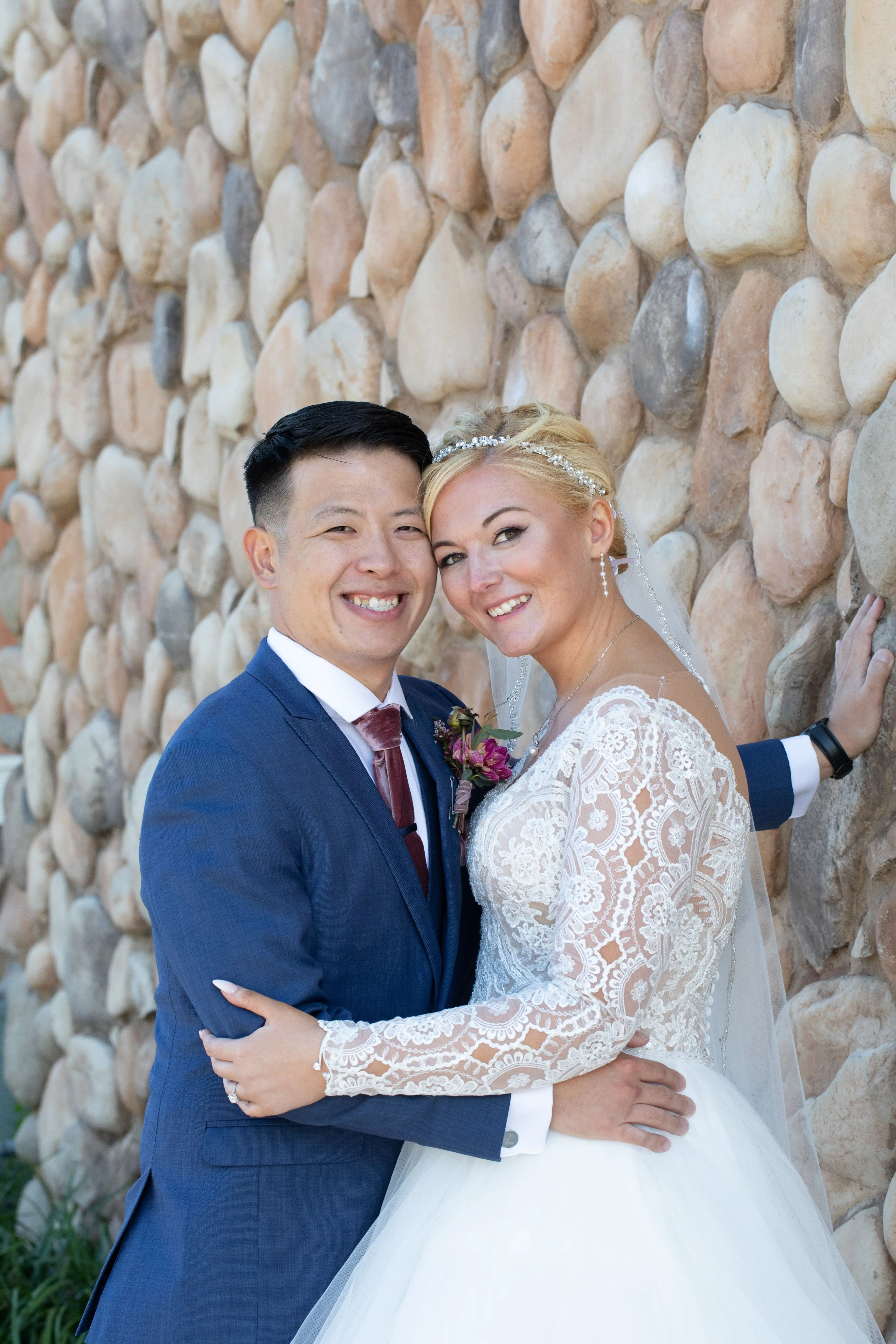 Bride Wearing Princess Ballgown Wedding Dress Called Mallory Dawn By Maggie Sottero Holding Groom Next To A Rock Walkl