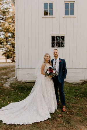Bride Wearing Square Neck Long Sleeve Floral Wedding Dress Called Sawyer By Sottero And Midgley With Groom Outside