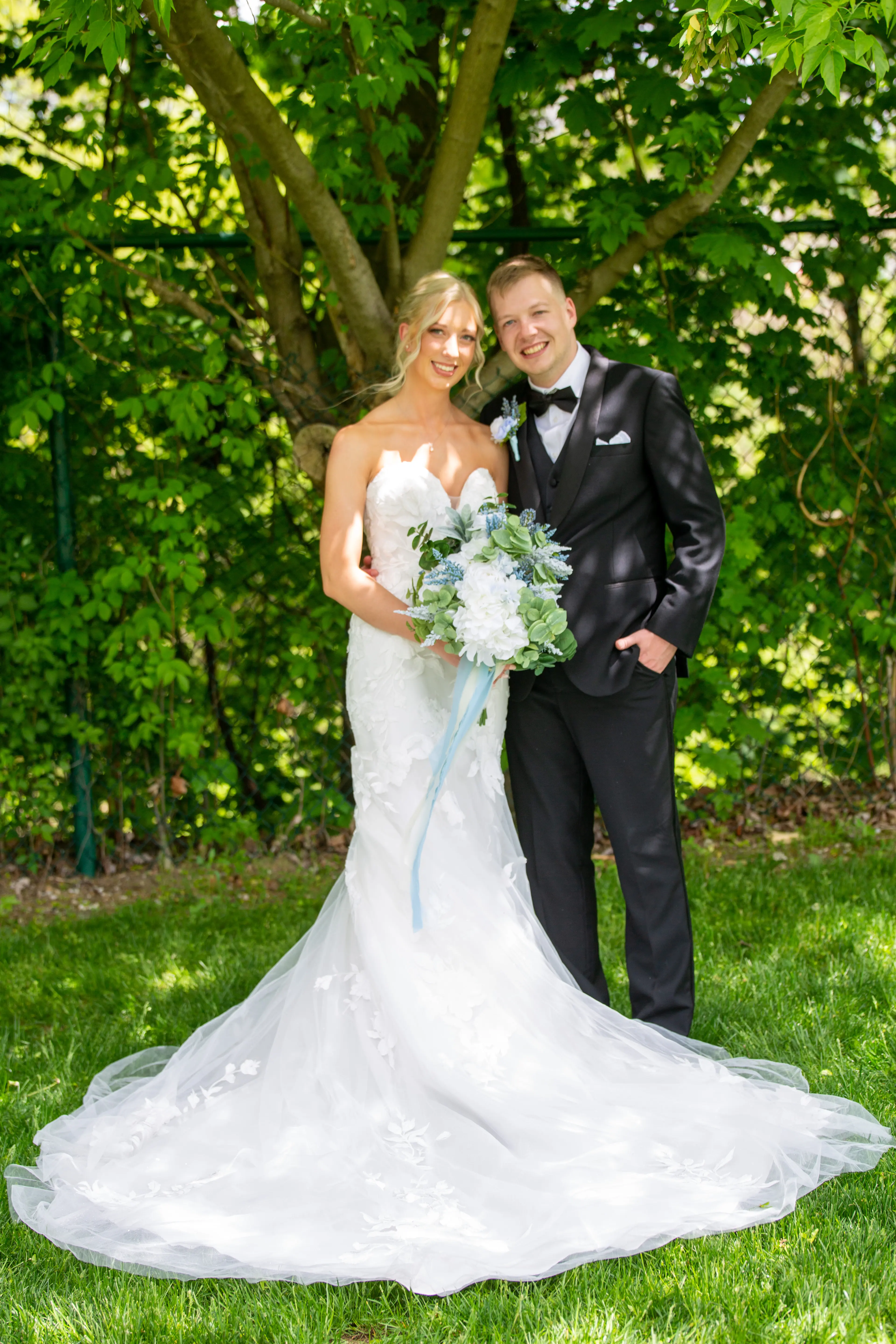 Groom with Real Bride in Strapless Mermaid Bridal Gown with Oversized Floral Lace Motifs over Sparkle Tulle called Hattie by Rebecca Ingram
