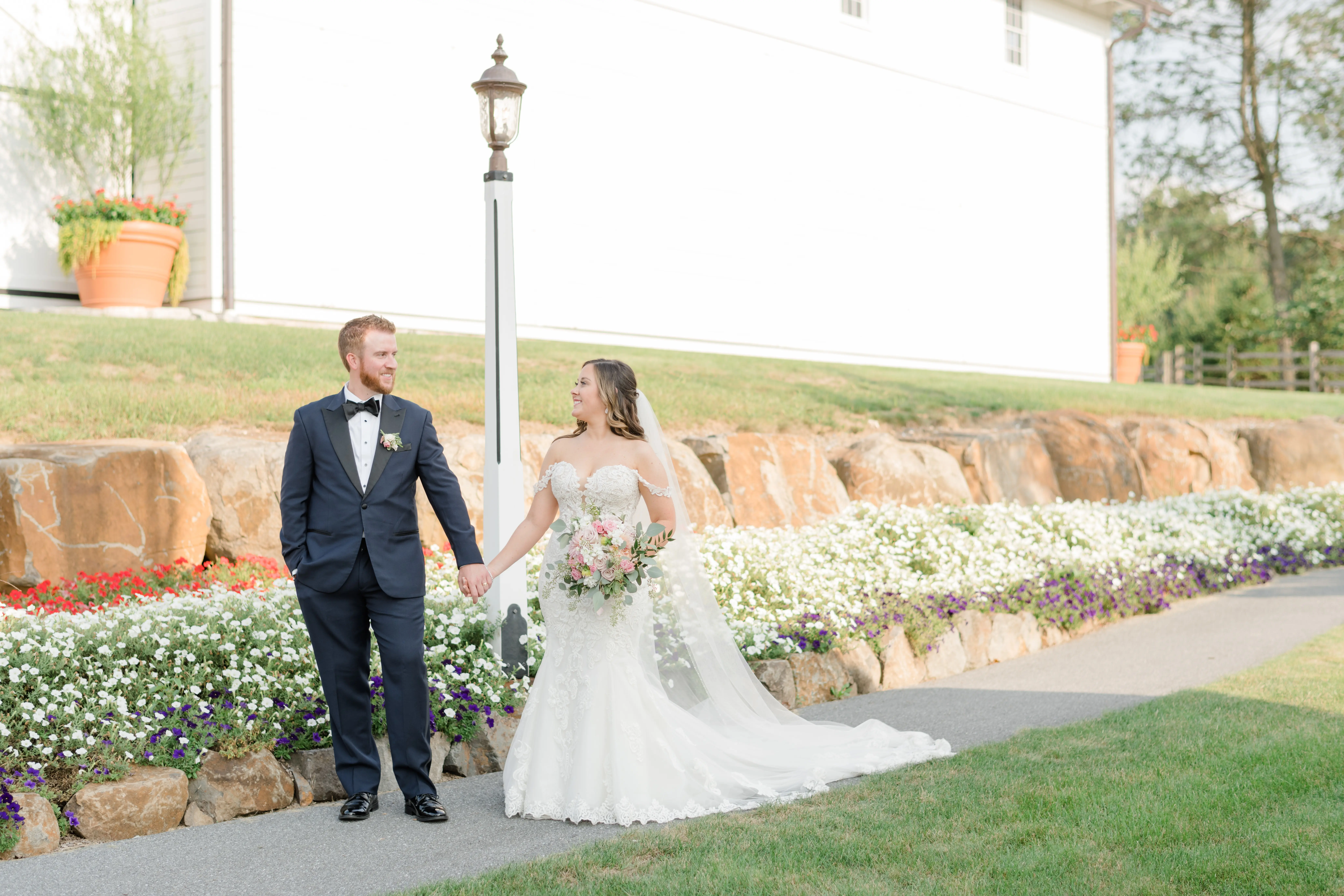 Real bride in sparkly lace fit-and-flare bridal dress with plunging illusion sweetheart neckline called Fiona by Maggie Sottero