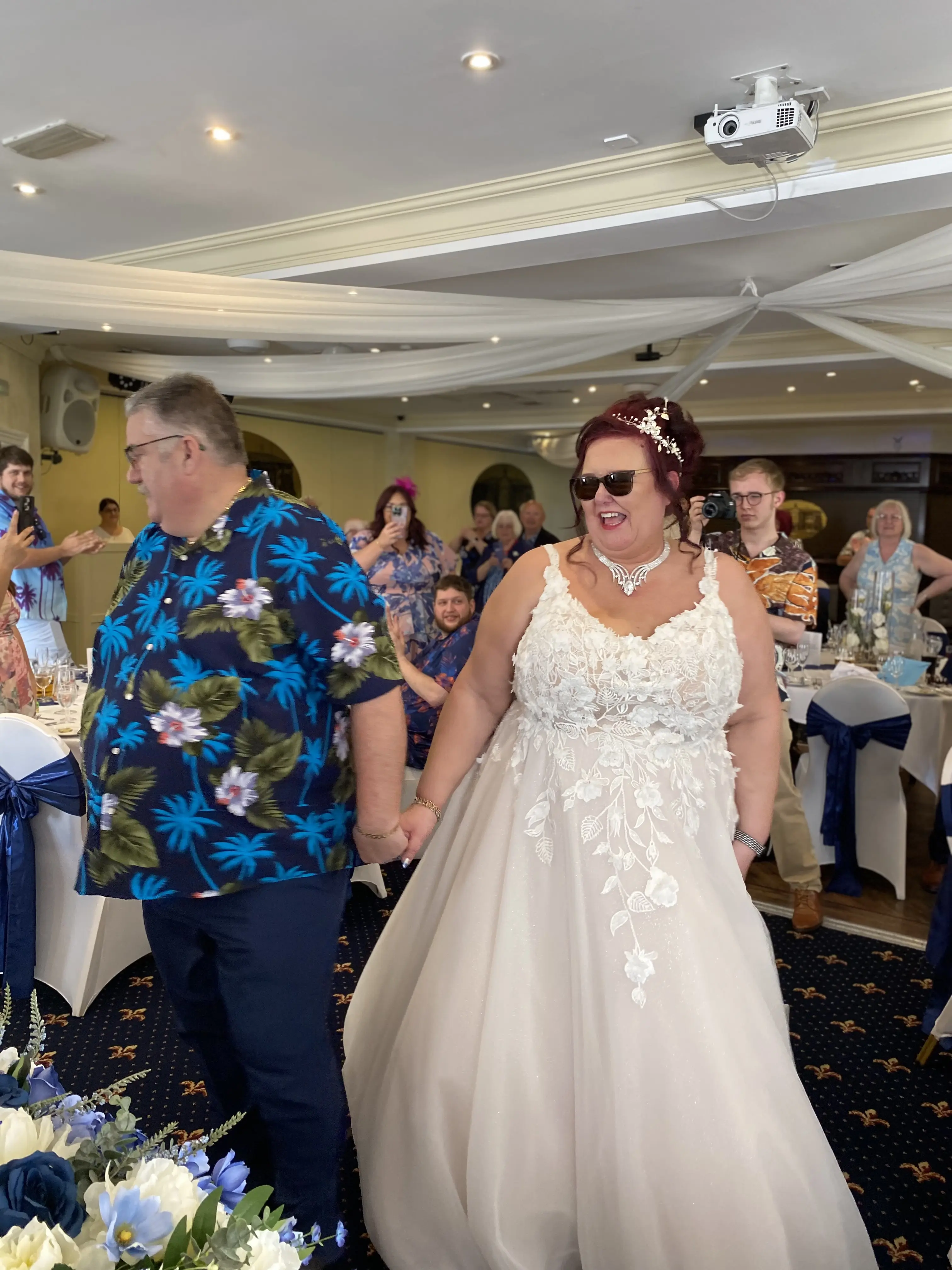 Bride wearing Natasha by Rebecca Ingram holding hands with her husband