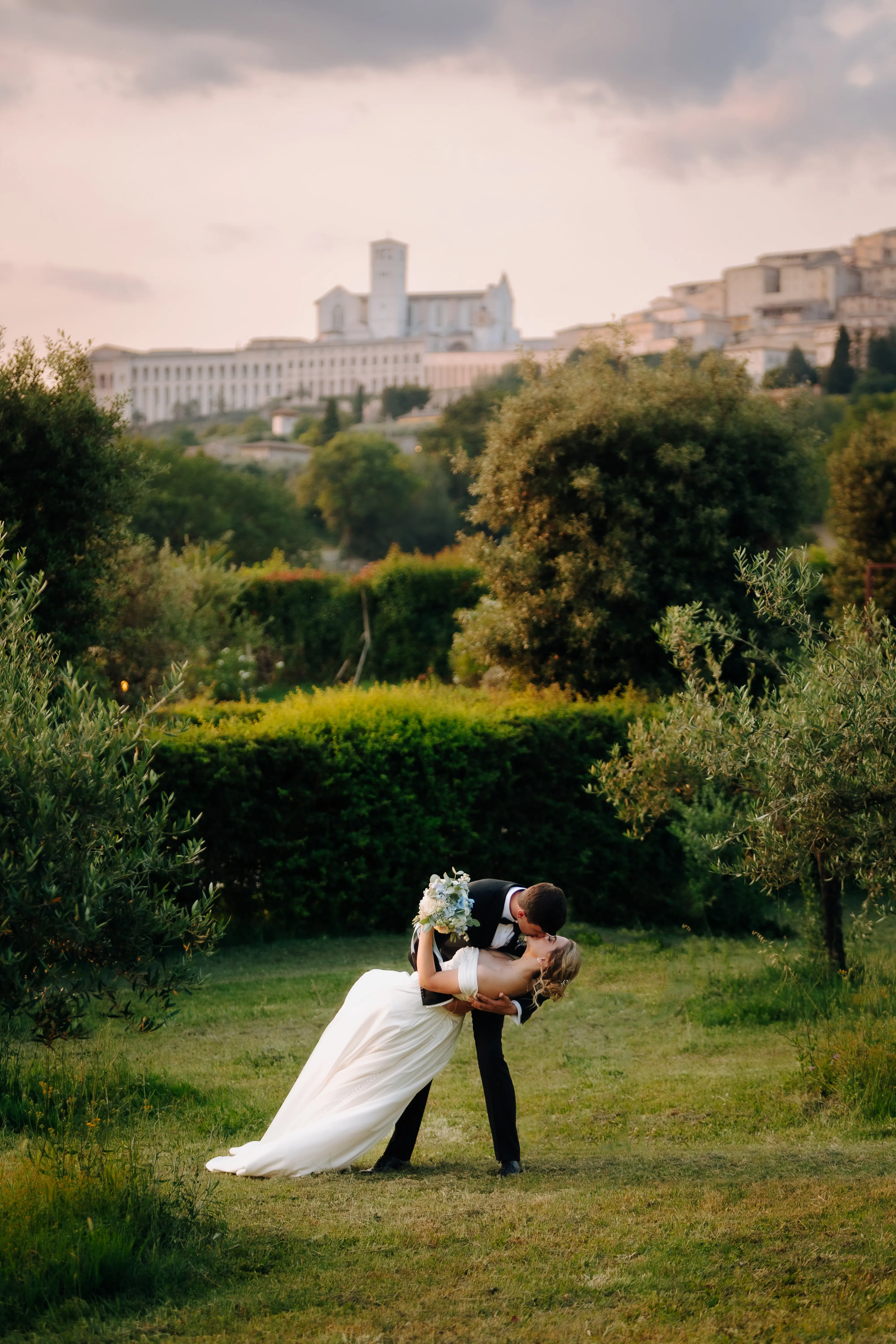 Groom Kissing Bride Wearing A-line Classic Wedding Dress Ekaterina By Maggie Sottero