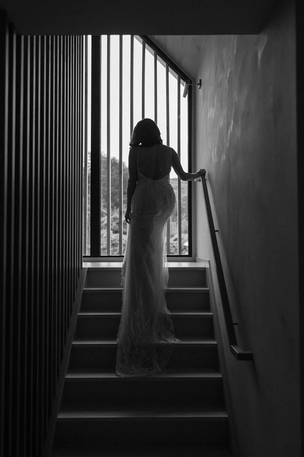 Bride wearing Luella wedding dress by Sottero and Midgley walking up the stairs