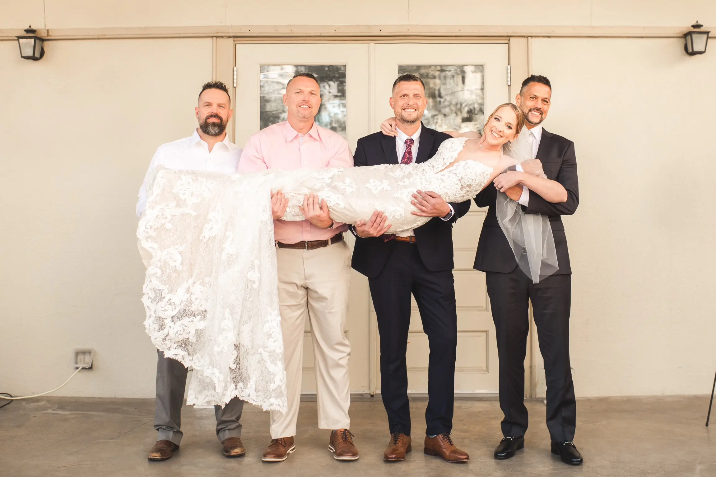 Bride Wearing Glamorous Lace And Sequin Wedding Dress Called Tuscany By Maggie Sottero Being Carried By Men Wedding Party