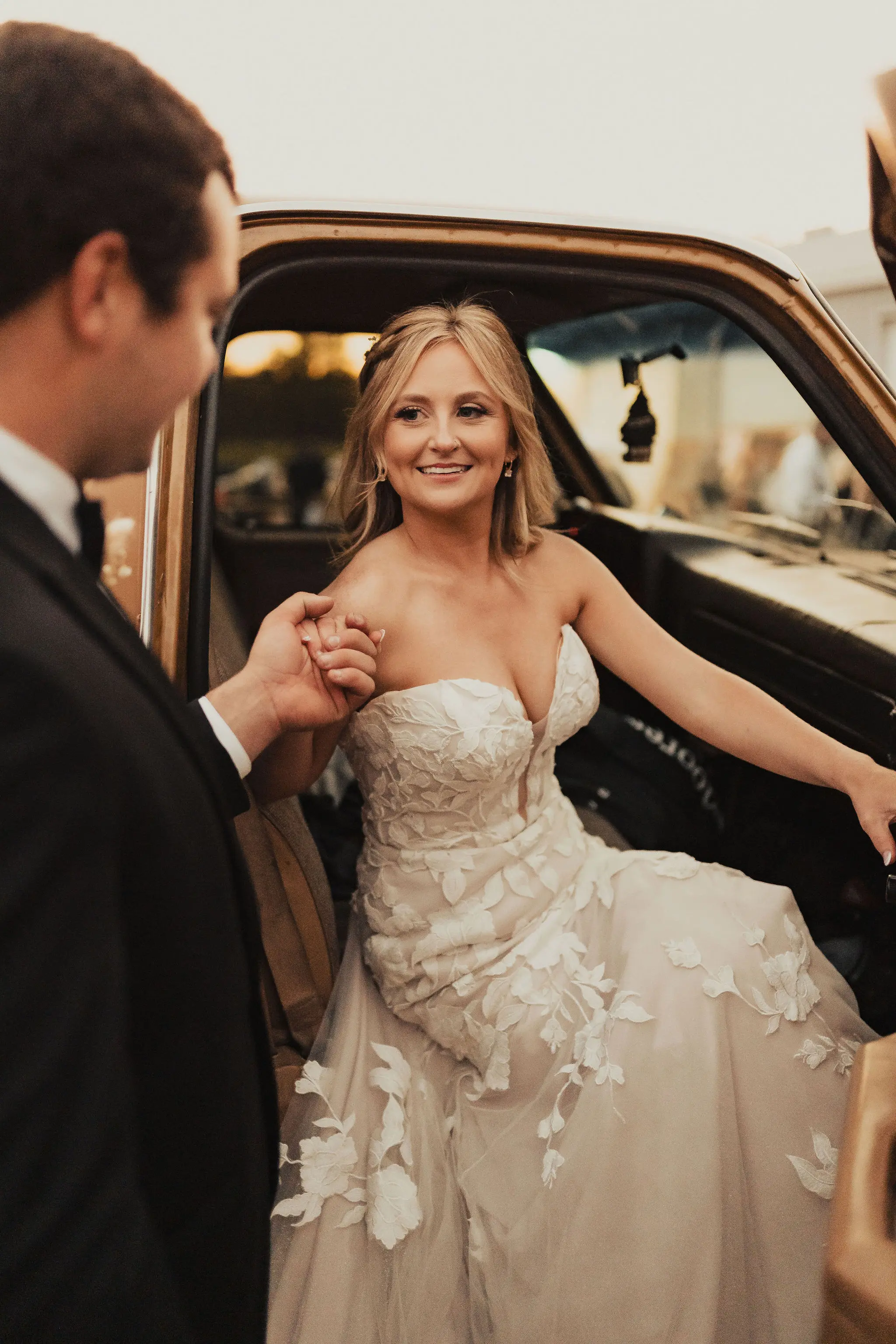 Bride in sweetheart neckline wedding dress called Hattie by Rebecca Ingram with groom