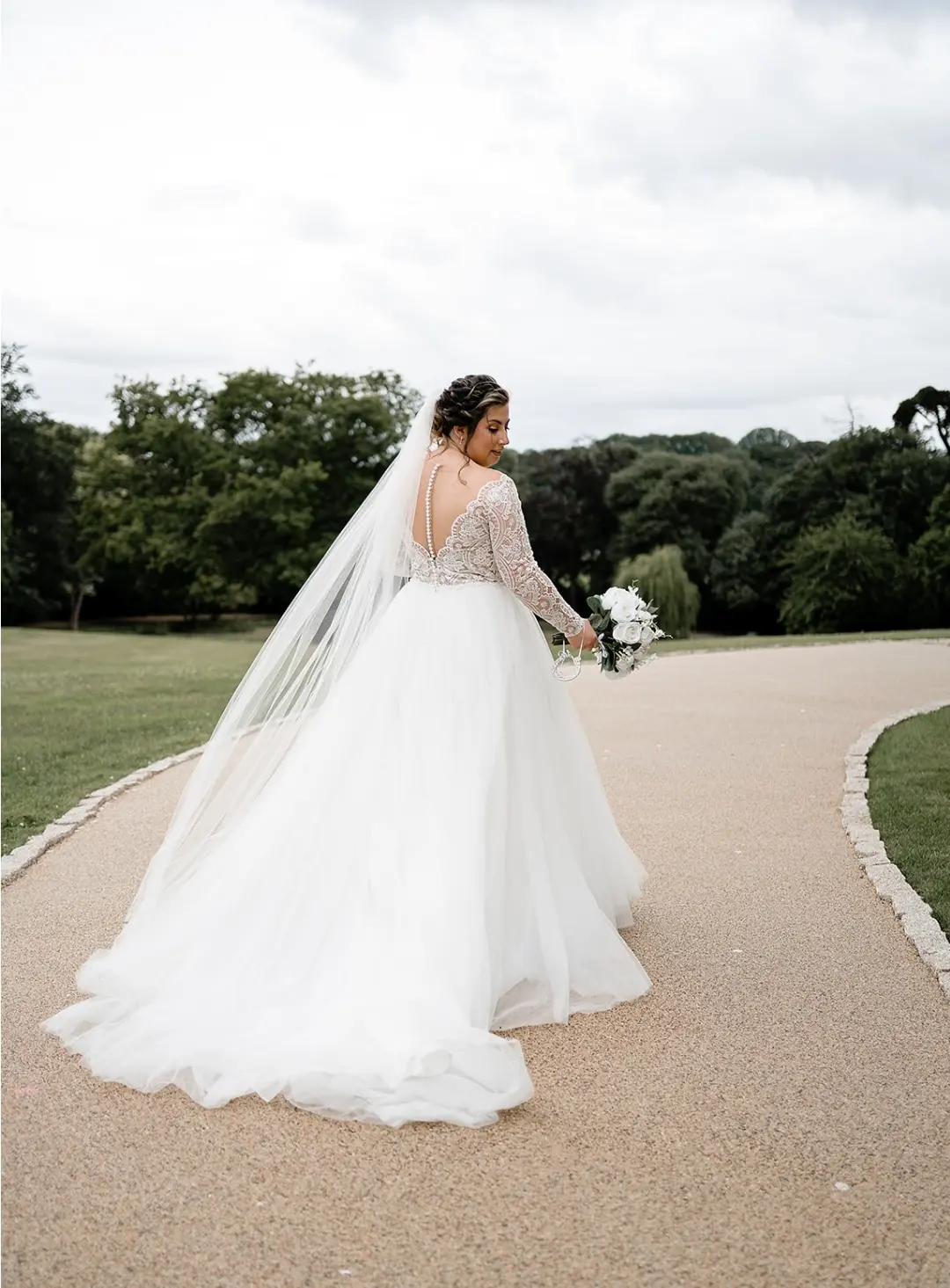 Bride From Back Walking on Road Wearing Bridal Gown Called Mallory Dawn by Maggie Sottero