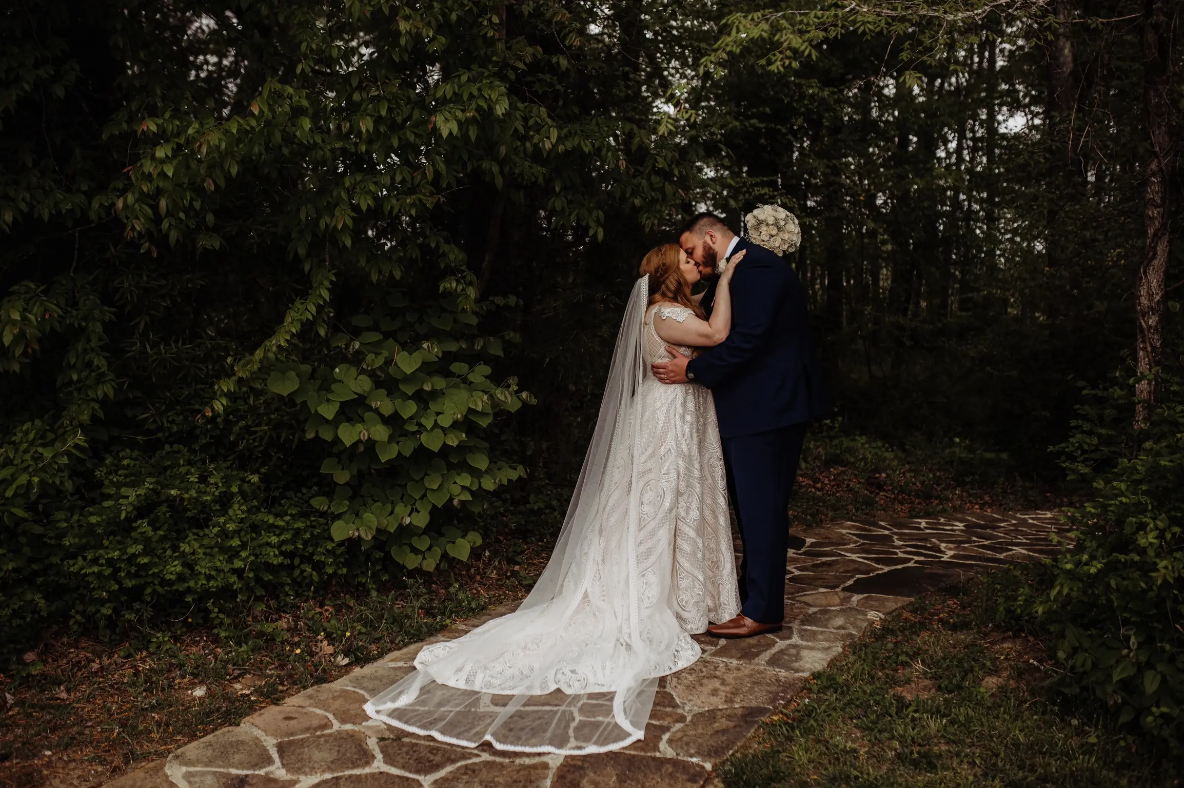 Groom Kissing Bride in A-Line Wedding Dress with Allover Sequin Lace Called Roxanne by Sottero & Midgley