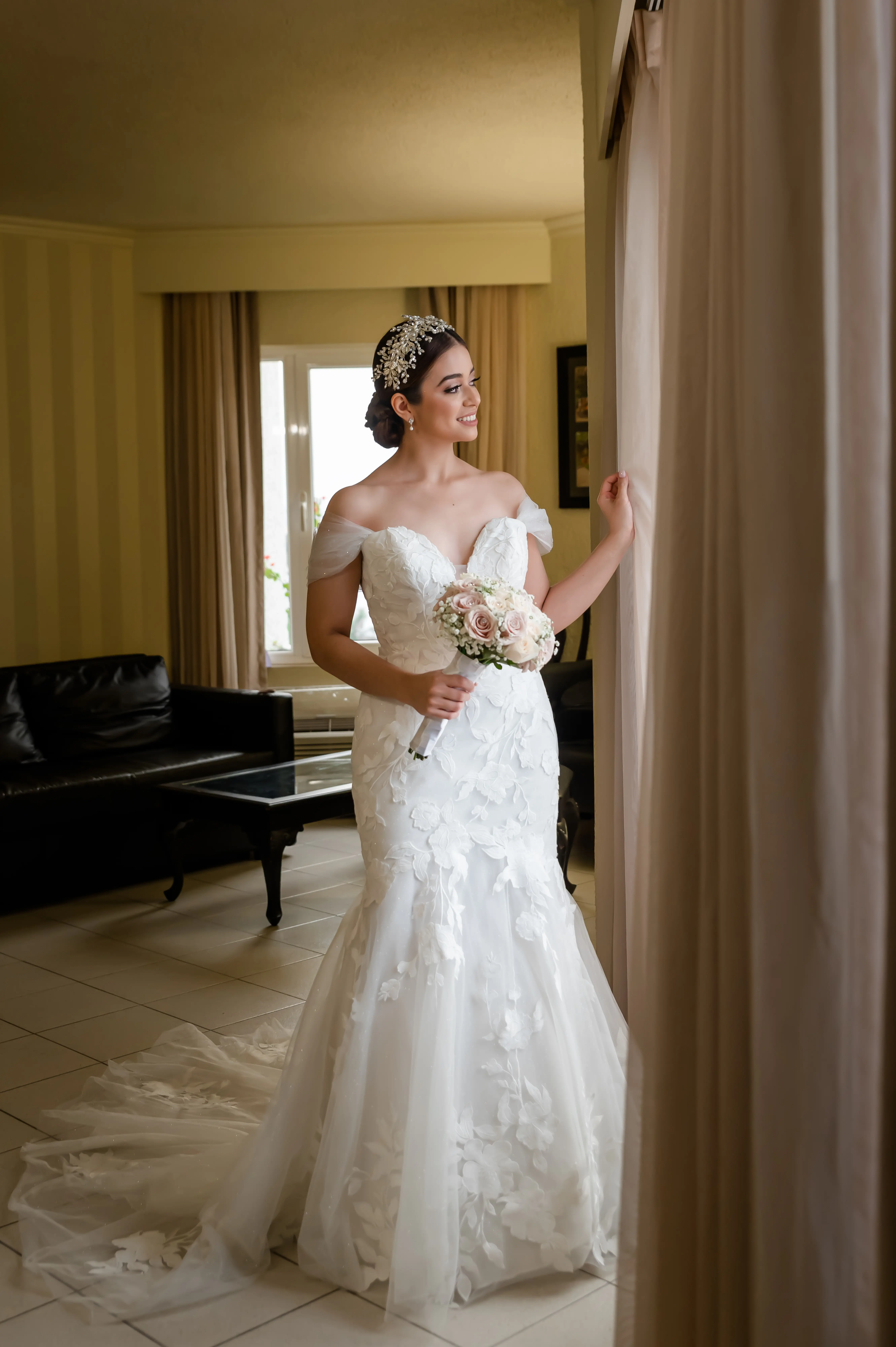 Bride Looking Out Window with Bouquet Wearing Wedding Dress Called Hattie by Rebecca Ingram
