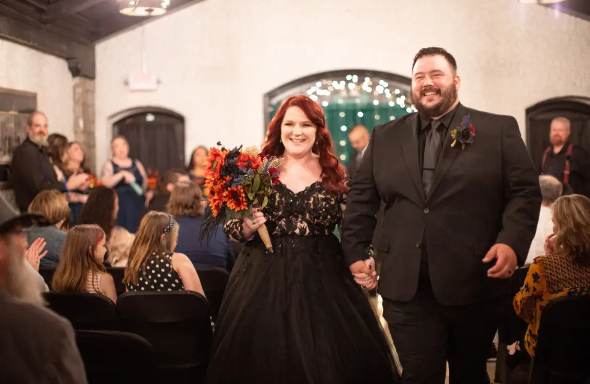 Bride wearing Zander wedding dress by Sottero and Midgley with her husband