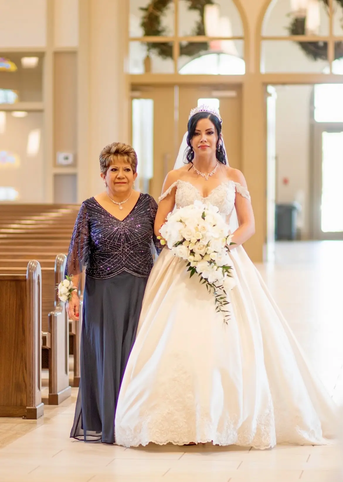 Bride wearing elegant satin ballgown called Kimora by Sottero and Midgley with mother