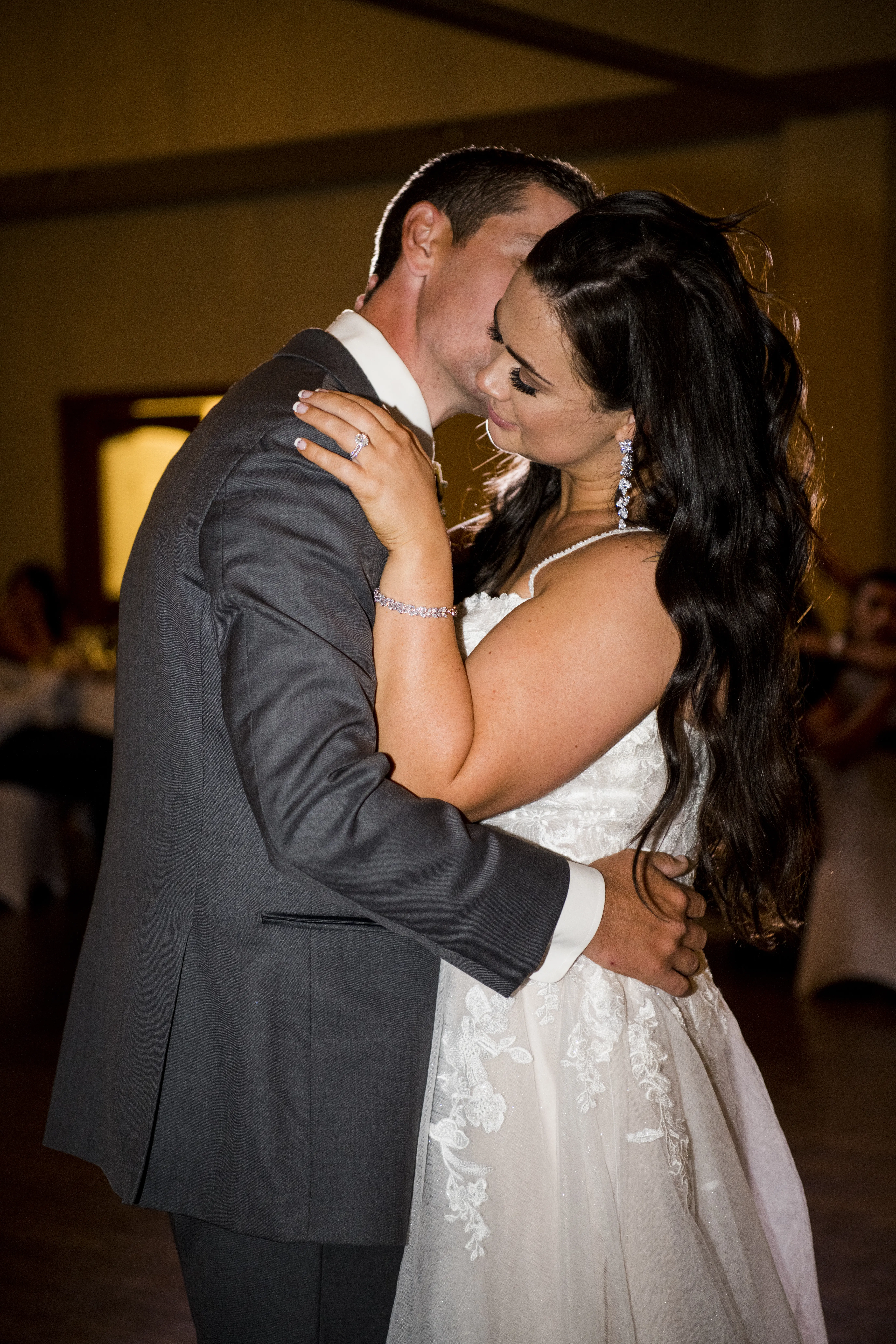 Bride wearing Princess Wedding Gown called Stevie by Maggie Sottero slow dancing with her groom