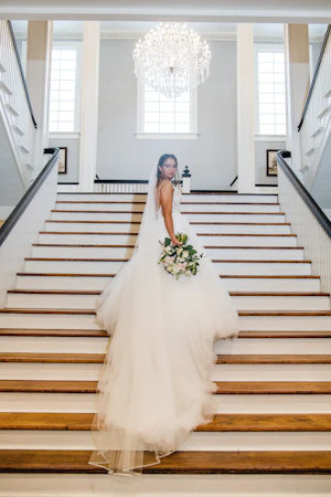 Bride wearing a boho princess wedding dress in lace and tulle