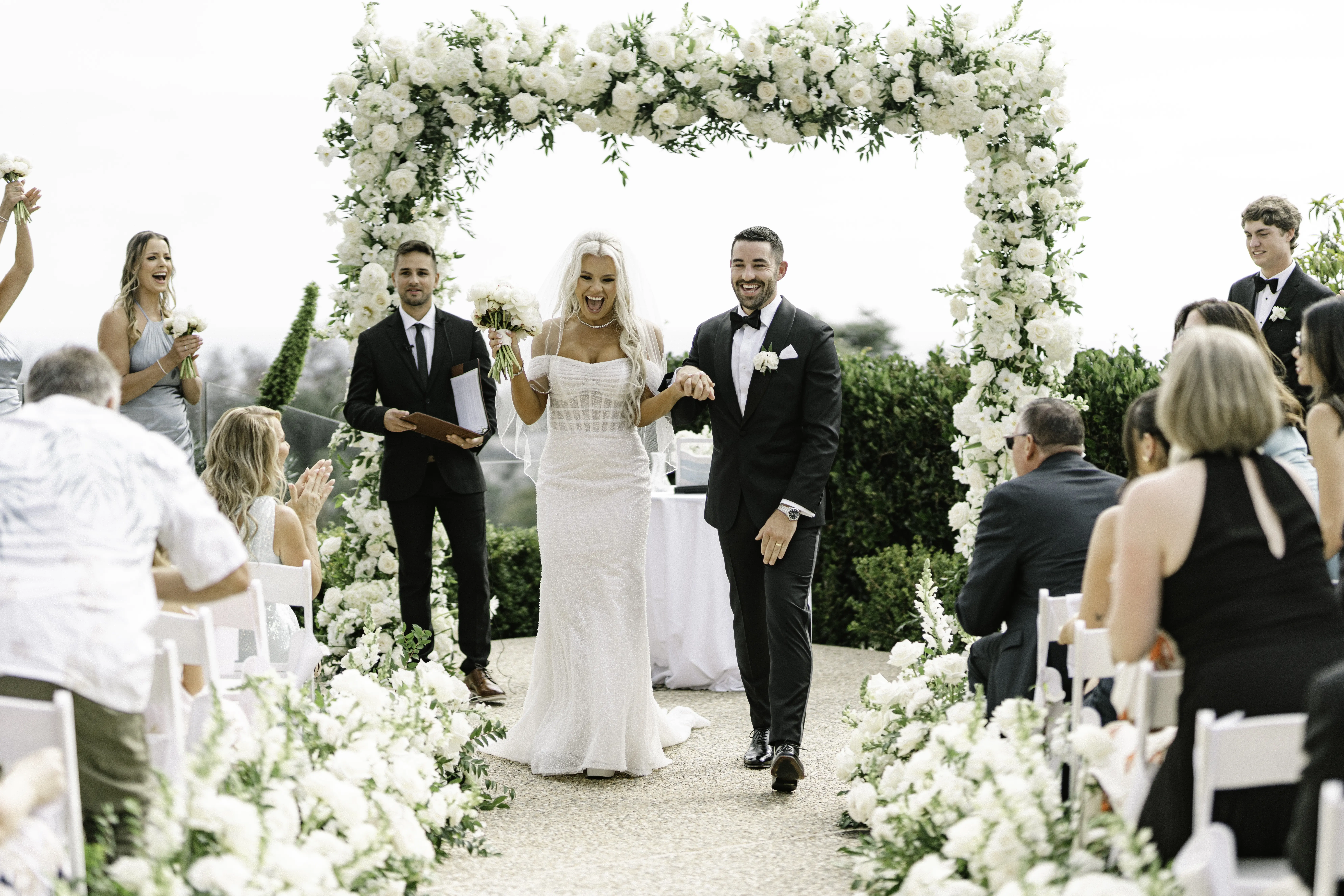 Bride Wearing Pearl Sparkly Bridal Gown Called Drew By Maggie Sottero With Groom At The Altar