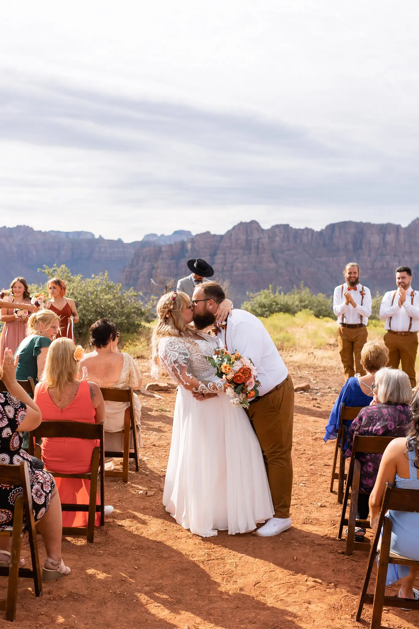 Real Bride in Long Sleeved, Thigh-High Slit Wedding Dress Named Lorraine by Rebecca Ingram with Groom in the Aisle